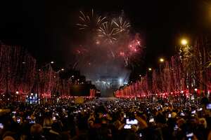 Fireworks explode over the Arc de Triomphe on the Champs-Elysees for New Year's celebrations in the French capital Paris on January 1, 2019. A fireworks display and sound and light show under the theme "fraternity" is set to go ahead on the Champs-Elysees despite plans for further "yellow vest" anti-government protests at the famed avenue. (Photo by Sameer Al-Doumy/NurPhoto via Getty Images)