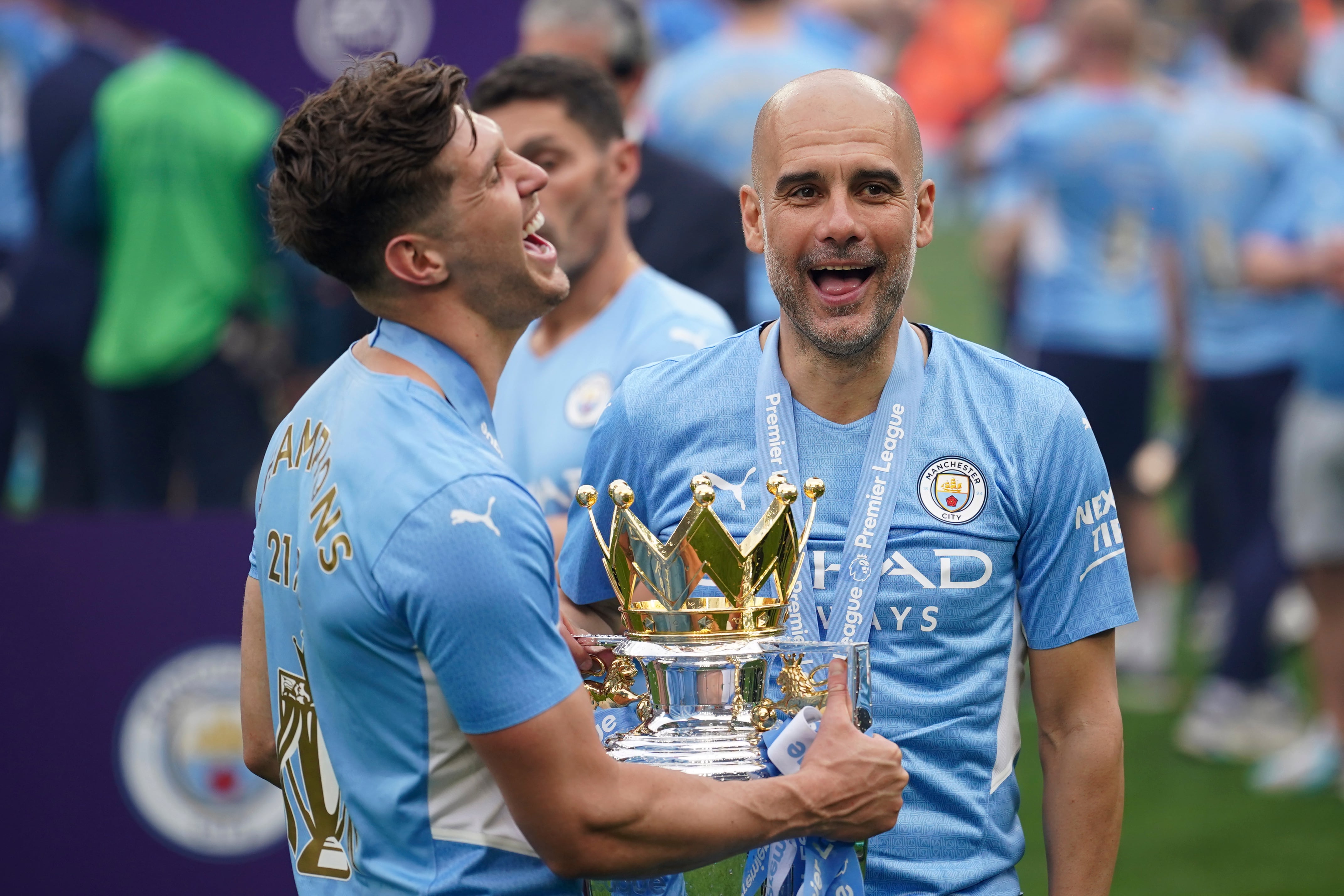 FILE - Manchester City's head coach Pep Guardiola, right, smiles with trophy after winning the 2022 English Premier League title at the Etihad Stadium in Manchester, England, on May 22, 2022. (AP Photo/Dave Thompson, File)