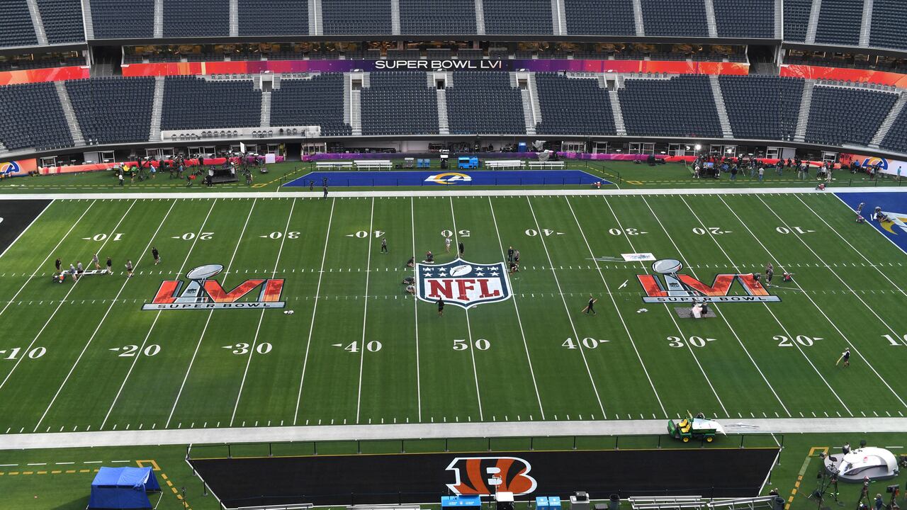 Workers prepare the field one day before Super Bowl LVI between the Los Angeles Rams and the Cincinatti Bengals at So-Fi Stadium in Inglewood, California on February 12, 2022. (Photo by VALERIE MACON / AFP)