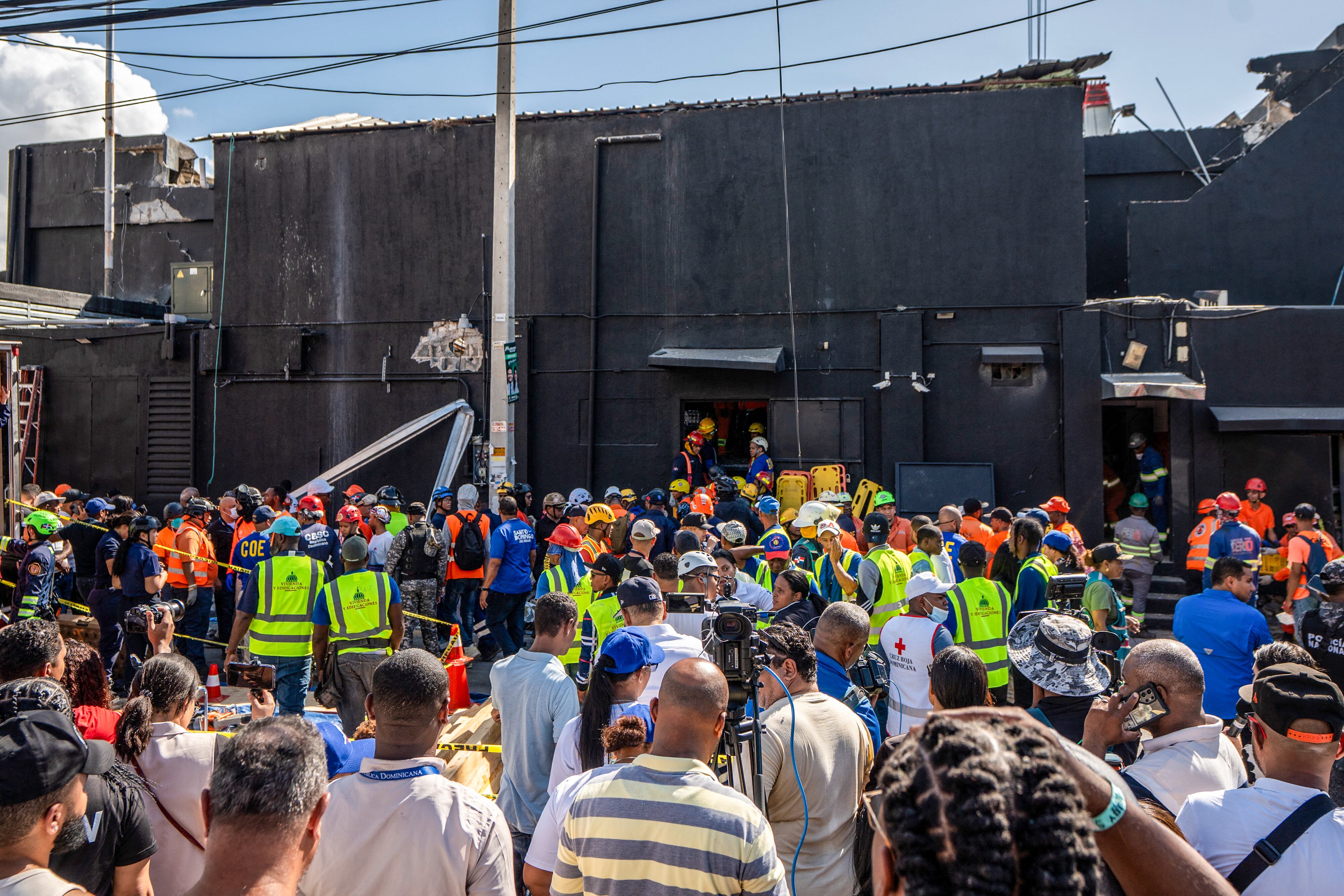 Personnel of Civil Defence and firefighters inspect the Jet Set nightclub after the collapse of its roof, in Santo Domingo, on April 8, 2025. At least 27 people were killed when the roof of a nightclub in the Dominican Republic collapsed early Tuesday morning, emergency services said, with rescue operations still underway. (Photo by Francesco SPOTORNO / AFP)