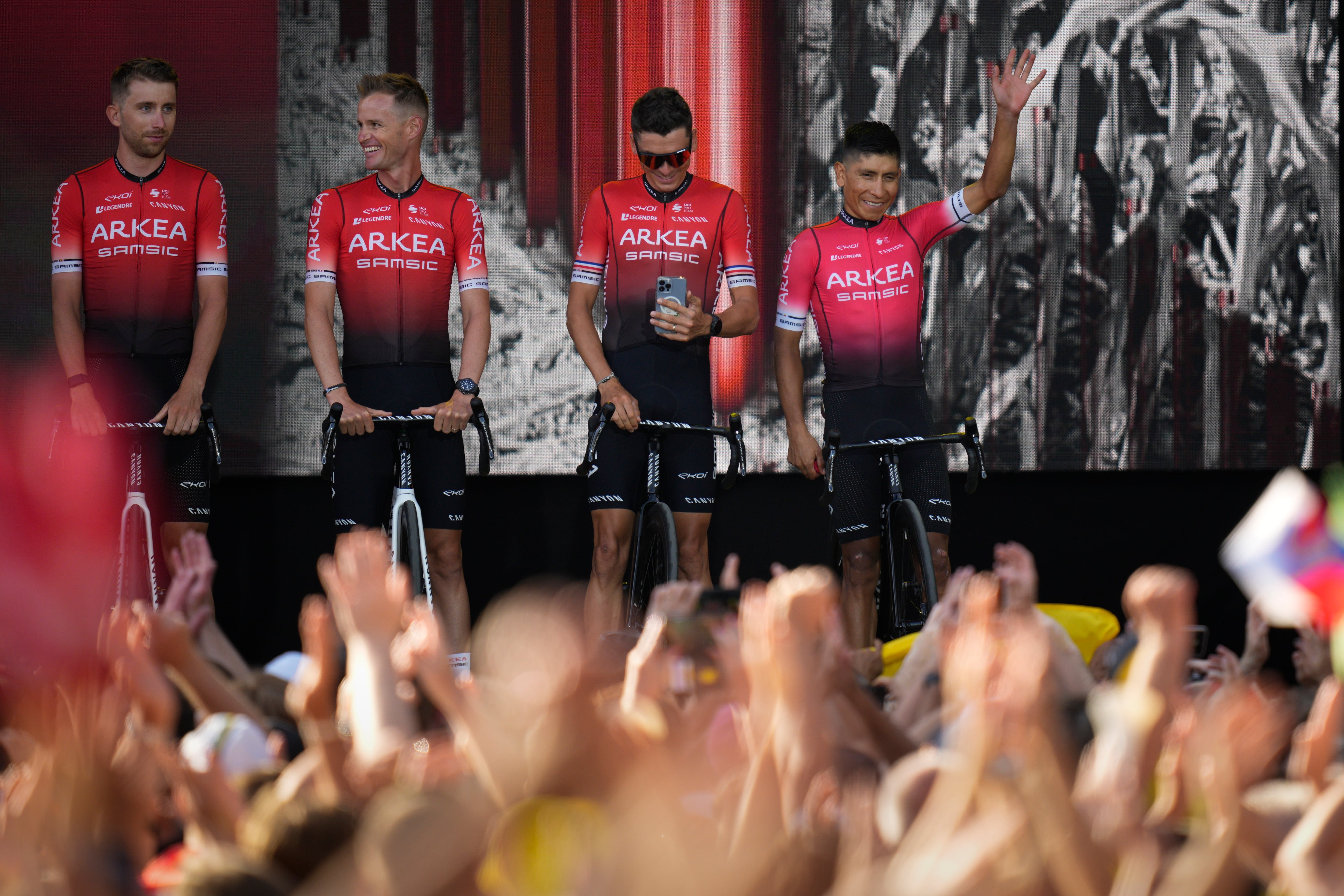 Colombia's Nairo Quintana, right, and other Arkea Samsic team riders greet cheering fans during the team presentation ahead of the Tour de France cycling race in Copenhagen, Denmark, Wednesday, June 29, 2022. The race starts Friday, July 1, the first stage is an individual time trial over 13.2 kilometers (8.2 miles) with start and finish in Copenhagen. (AP Photo/Daniel Cole)