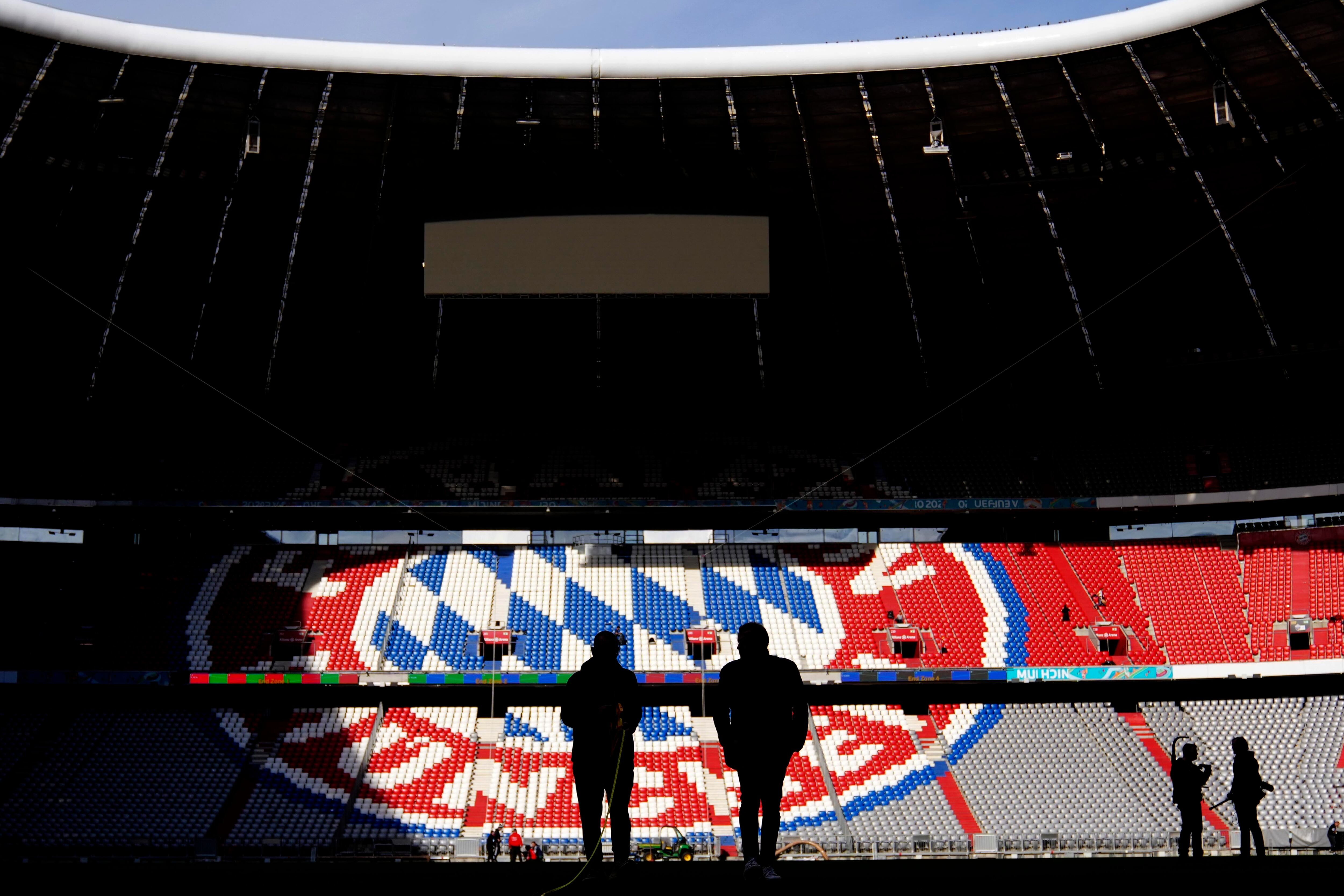 FILE - Workers prepare the FC Bayern Munich soccer stadium Allianz Arena in Munich, Germany, Wednesday, Nov. 9, 2022. German soccer giant Bayern Munich has been reprimanded and fined by the Munich customs office for not paying its workers the minimum wage. (AP Photo/Matthias Schrader, File)