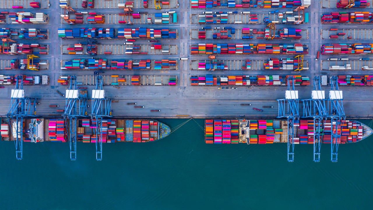 Container ship is loading in a port, Aerial top view container ship.