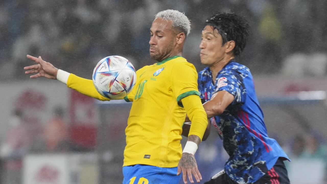 Neymar of Brazil, left, fights for the ball against Genki Haraguchi of Japan during a friendly match with Japan's team at the National Stadium in Tokyo Monday, June 6, 2022. (AP/Eugene Hoshiko)