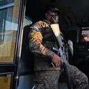 A soldier is seen on a public transport bus in San Salvador on March 16, 2022. - The government intervened two routes of collective transport after the illegal increase in the cost of the ticket by now captured transport entrepreneur Catalino Miranda, who is also charged with the crimes of resistance and public disorder. (Photo by MARVIN RECINOS / AFP)