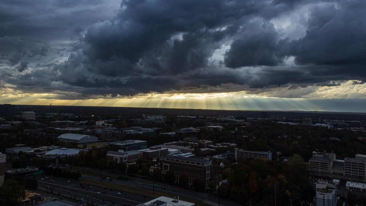 Sunbeams shine through dark, ominous storm clouds over midtown Atlanta