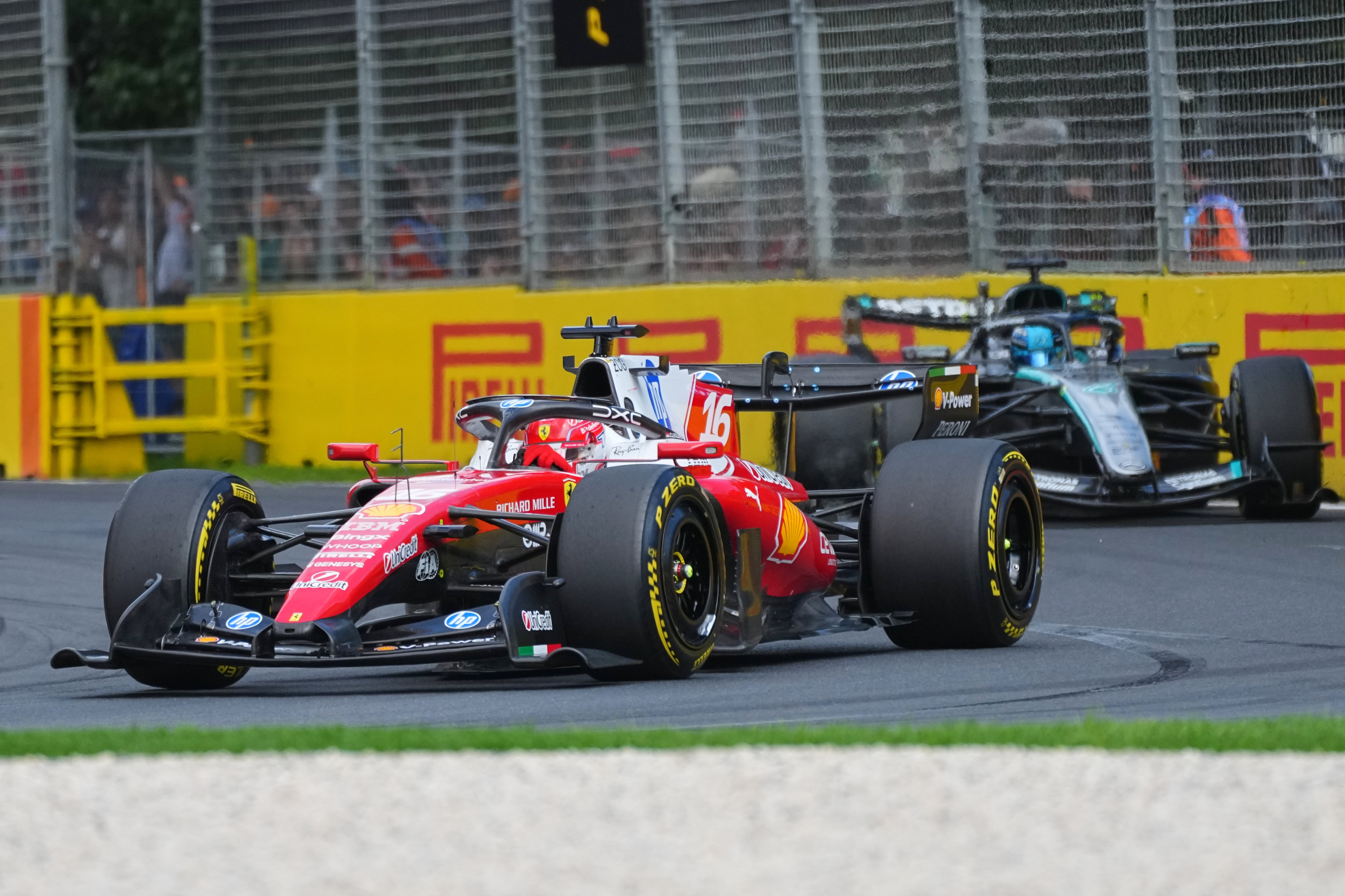 Ferrari driver Charles Leclerc of Monaco leads Mercedes driver George Russell of Britain out of turn three during the Australian Formula One Grand Prix at Albert Park, in Melbourne, Australia, Sunday, March 8, 2026. (AP Photo/Scott Barbour)