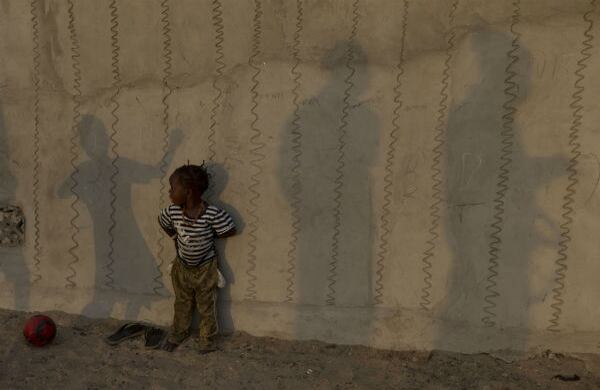 Una niña juega en frente de un muro decorado en San Luis, Senegal, la ciudad que alguna vez fue la capital de la colonia francesa en el occidente de África. (AP)