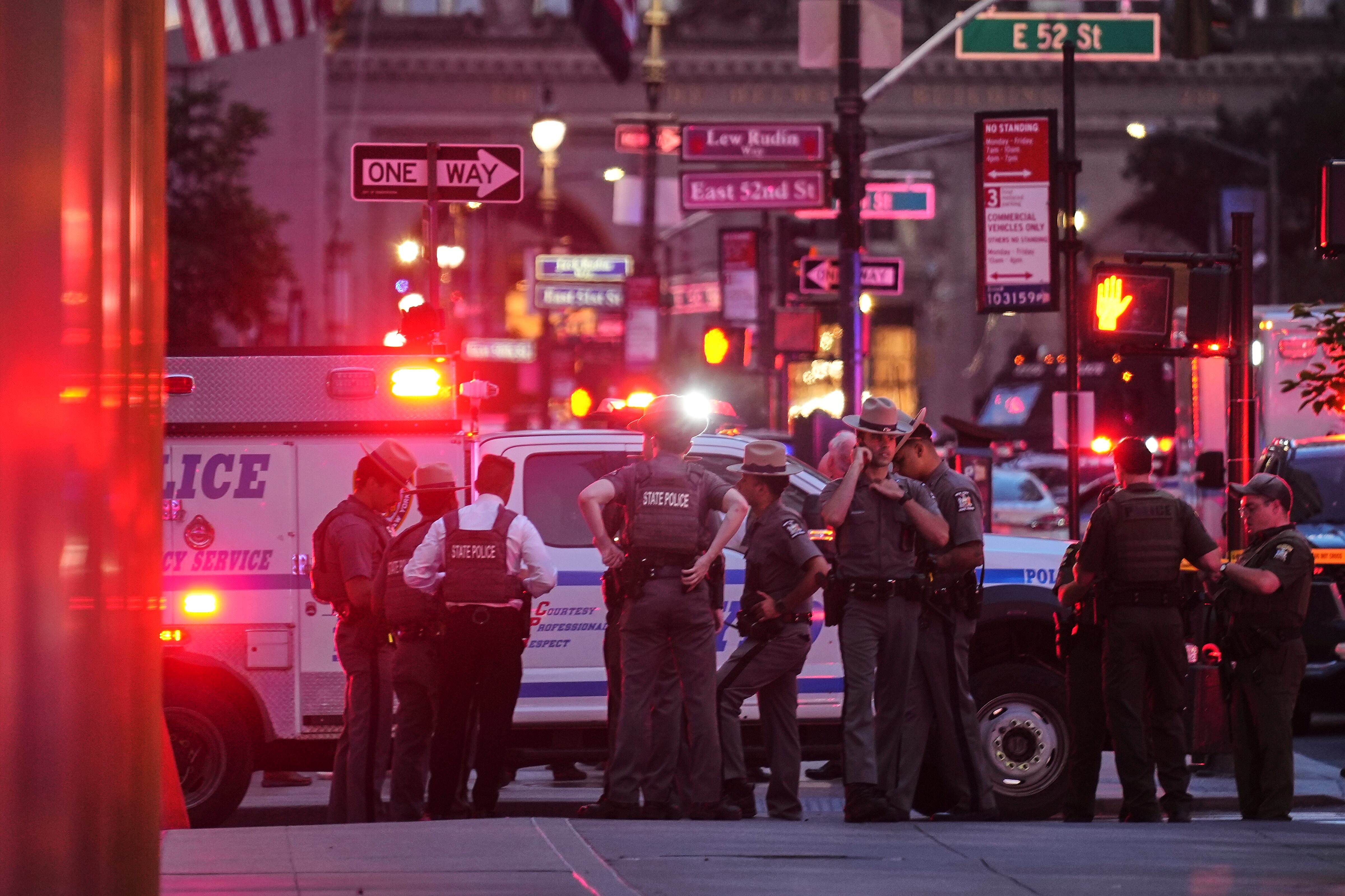 New York State Police troopers gather on 52nd Street outside a Manhattan office building where two people were shot, including a New York police officer, Monday, July 28, 2025, in New York. (AP Photo/Angelina Katsanis)