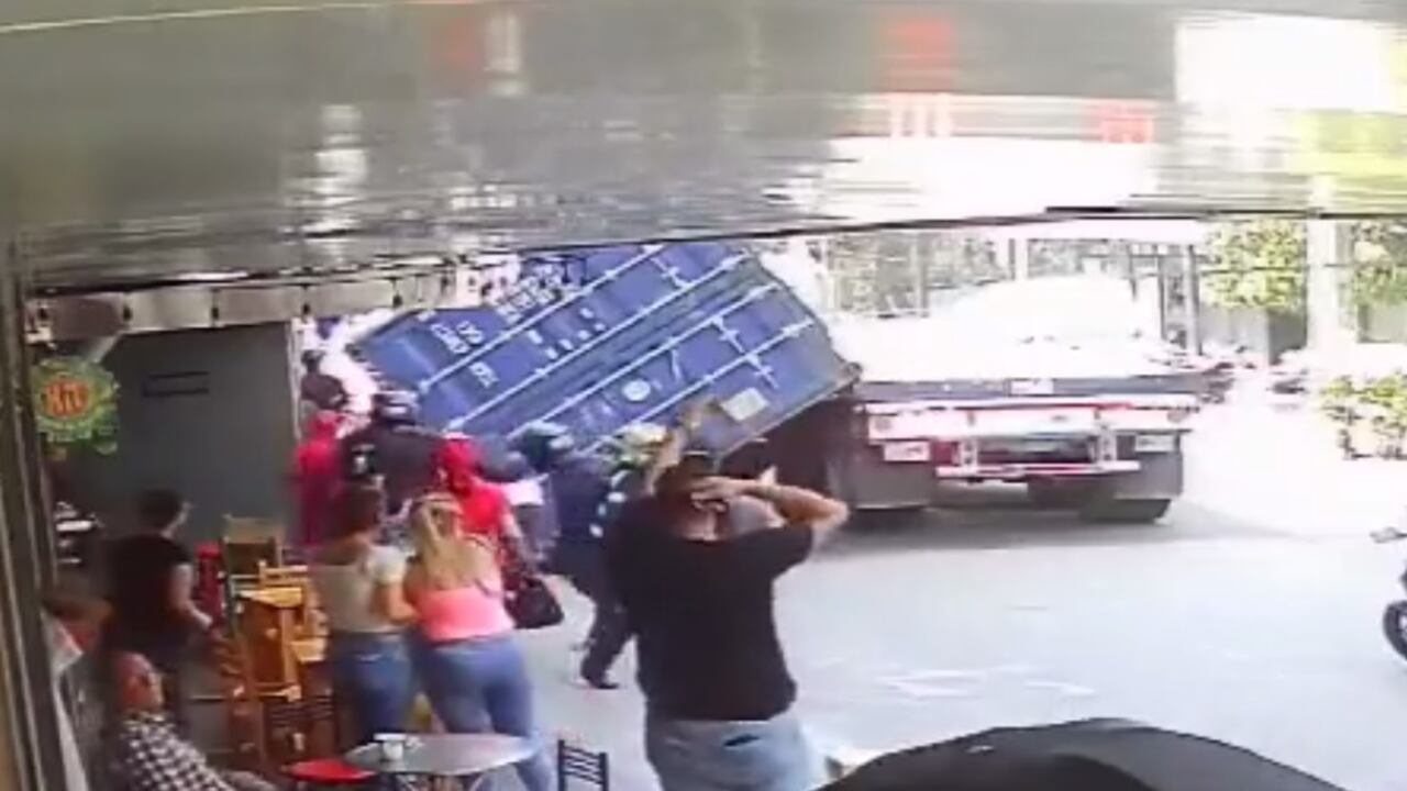 Se aprecia el momento en el que un motociclista estuvo a punto de ser aplastado por un contenedor.