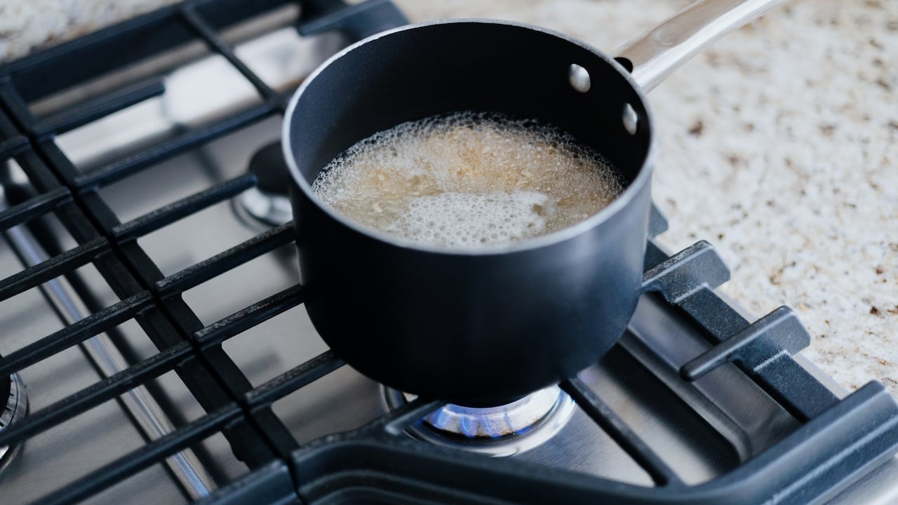 Close-up of food boiling in pot on gas cooktop