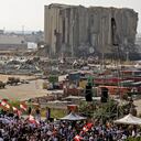 Demonstrators gather near the damaged grain silos outside the port of Lebanon's capital Beirut on August 4, 2021, on the first anniversary of the blast that ravaged the port and the city. - Hundreds of Lebanese marched on August 4 to mark a year since a cataclysmic explosion ravaged Beirut, protesting impunity over the country's worst peacetime disaster at a time when its economy was already in tatters. (Photo by JOSEPH EID / AFP)