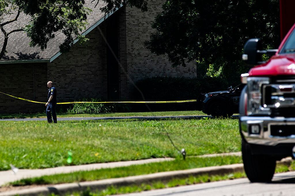 WAYNE, MICHIGAN - JUNE 22: A police officer on the scene of a shooting at CrossPointe Community Church on June 22, 2025 in Wayne, Michigan. Police report that a shooting suspect was shot dead by a security guard after opening fire at the church leaving one person injured. (Photo by Emily Elconin/Getty Images)