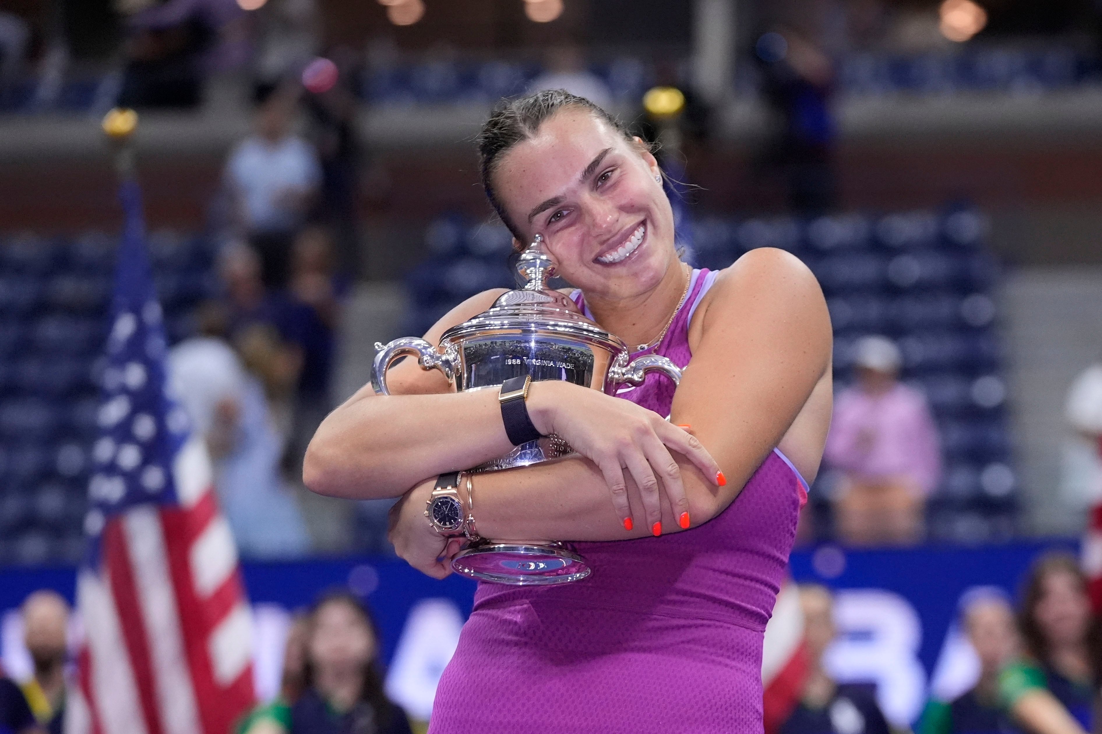 Aryna Sabalenka, of Belarus, hugs the trophy after winning the women's singles final of the U.S. Open tennis championships against Jessica Pegula, of the United States, , Saturday, Sept. 7, 2024, in New York. (AP Photo/Frank Franklin II)