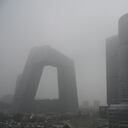 Buildings are seen in the central business district on a polluted day in Beijing on November 5, 2021. (Photo by JADE GAO / AFP)