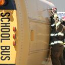 School Bus wreck with Firemen working on getting the students out.