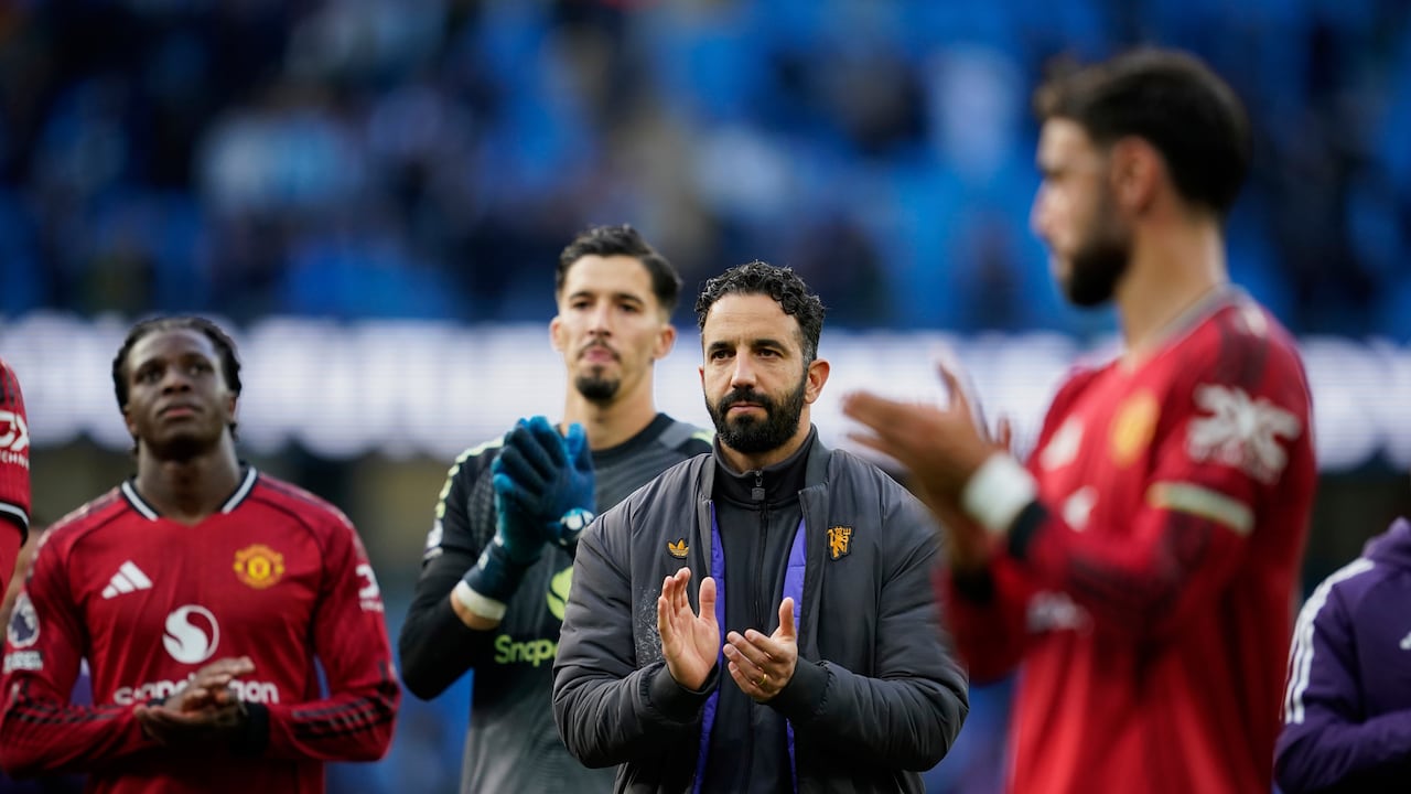 Manchester United's head coach Ruben Amorim and players walk off the pitch after the Premier League soccer match between Manchester City and Manchester United in Manchester, England, Sunday, Sept. 14, 2025. (AP Photo/Dave Thompson)