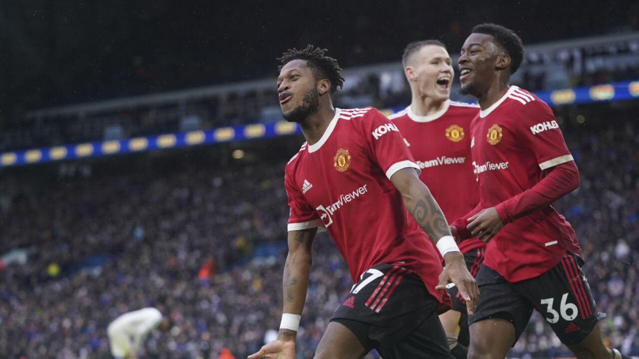 Manchester United's Fred, left, celebrates after scoring his side's third goal during the English Premier League soccer match between Leeds United and Manchester United, at Elland Road Stadium in Leeds, England, Sunday, Feb. 20, 2022. (AP Photo/Jon Super)