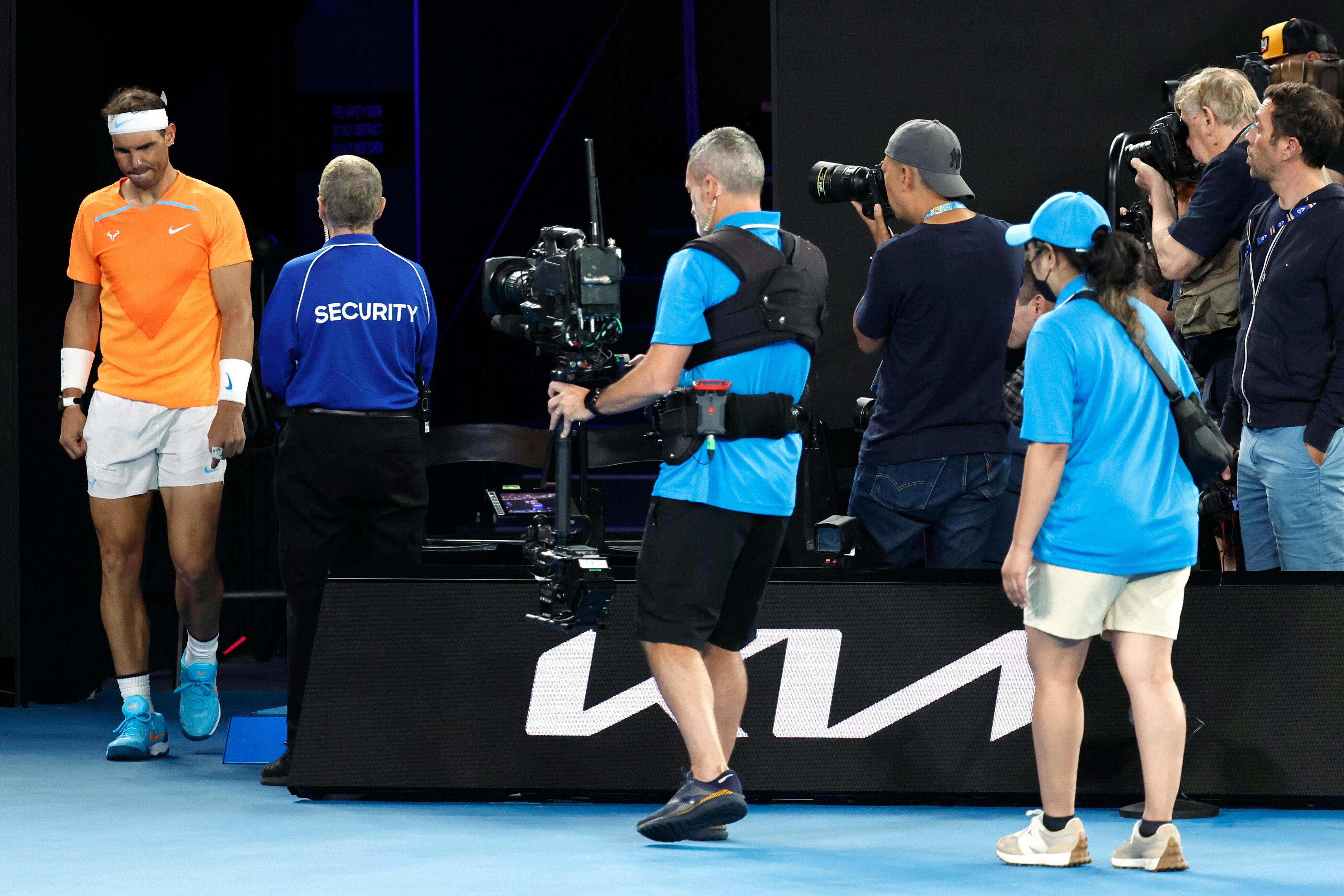 Rafael Nadal of Spain walks back onto the court after medial time out during his second round match against Mackenzie McDonald of the U.S., at the Australian Open tennis championship in Melbourne, Australia, Wednesday, Jan. 18, 2023. (AP Photo/Asanka Brendon Ratnayake)