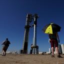 Onlookers watch as SpaceX's mega rocket Starship is prepared for its upcoming launch from Starbase in Boca Chica, Texas, Friday, Nov. 17, 2023. (AP Photo/Eric Gay)