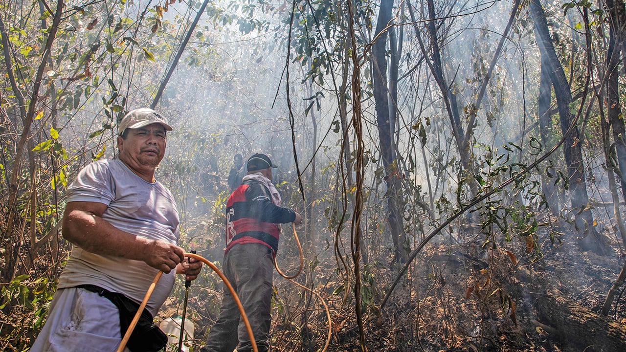Habitantes de las zonas afectadas por los incendios luchan para controlar la emergencia.