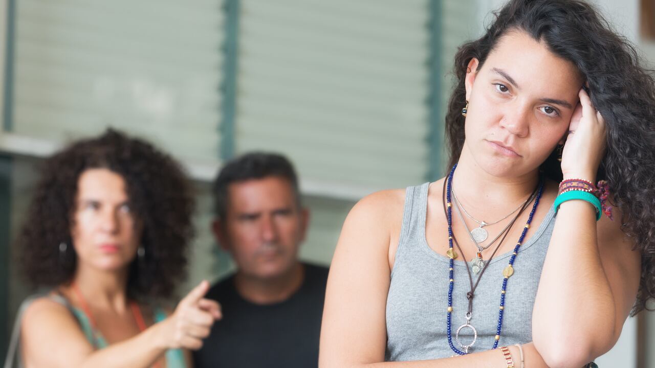 Very upset parents scolding their daughter