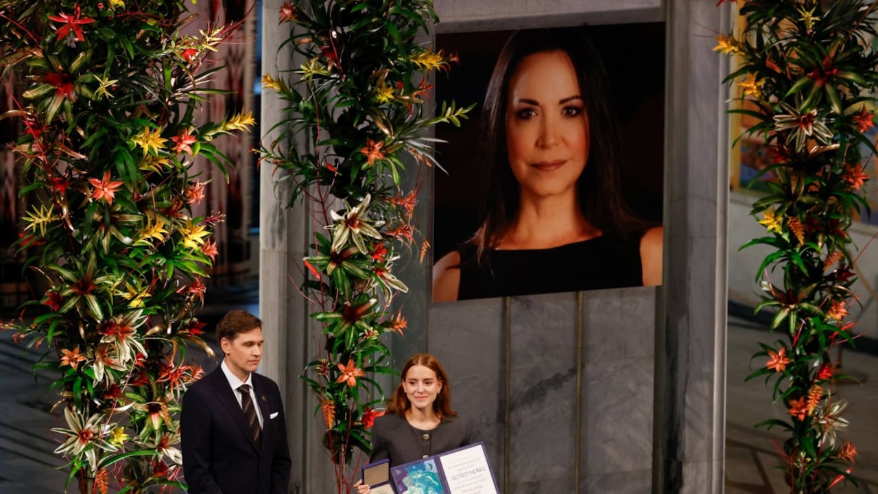 Ana Corina Sosa (R), hija de la líder de la oposición venezolana María Corina Machado, recibe el Premio Nobel de la Paz para su madre de manos del presidente del Comité Nobel Noruego, Jorgen Watne Frydnes (L), en la ceremonia del Premio Nobel de la Paz en el Ayuntamiento de Oslo el 10 de diciembre de 2025 en Oslo, Noruega. El Premio Nobel de la Paz 2025 fue otorgado a Machado por sus esfuerzos por llevar la democracia a Venezuela, desafiando el gobierno de mano dura del presidente venezolano Nicolás Maduro, quien ha sido presidente desde 2013. (Foto de Odd ANDERSEN / AFP)