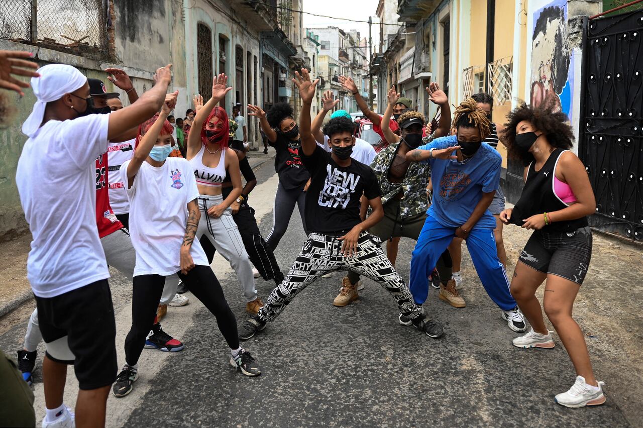 Dancers perform in a street of Havana, on May 21, 2021. - Driven by social networks, a troupe of young Cubans has attracted the attention of several stars abroad with their choreographies that mix hip-hop, reggaeton and salsa. (Photo by YAMIL LAGE / AFP)