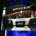 SpaceX CEO Elon Musk, displayed on a screen remotely from SpaceX headquarters in Starbase, Texas, speaks before the launch of SpaceX�s initial public offering (IPO) at the Nasdaq MarketSite in New York on June 12, 2026. Elon Musk's SpaceX begins trading on the Nasdaq exchange on Friday with the biggest initial public offering in history expected to make the polarizing entrepreneur the world's first trillionaire. The company priced more than 555 million shares at $135 each in a filing with the US markets regulator on Thursday, placing SpaceX in the top 10 of Wall Street's biggest companies with a valuation of just under $1.8 trillion -- ahead of Tesla, Facebook-owner Meta and Walmart. (Photo by TIMOTHY A. CLARY / AFP)