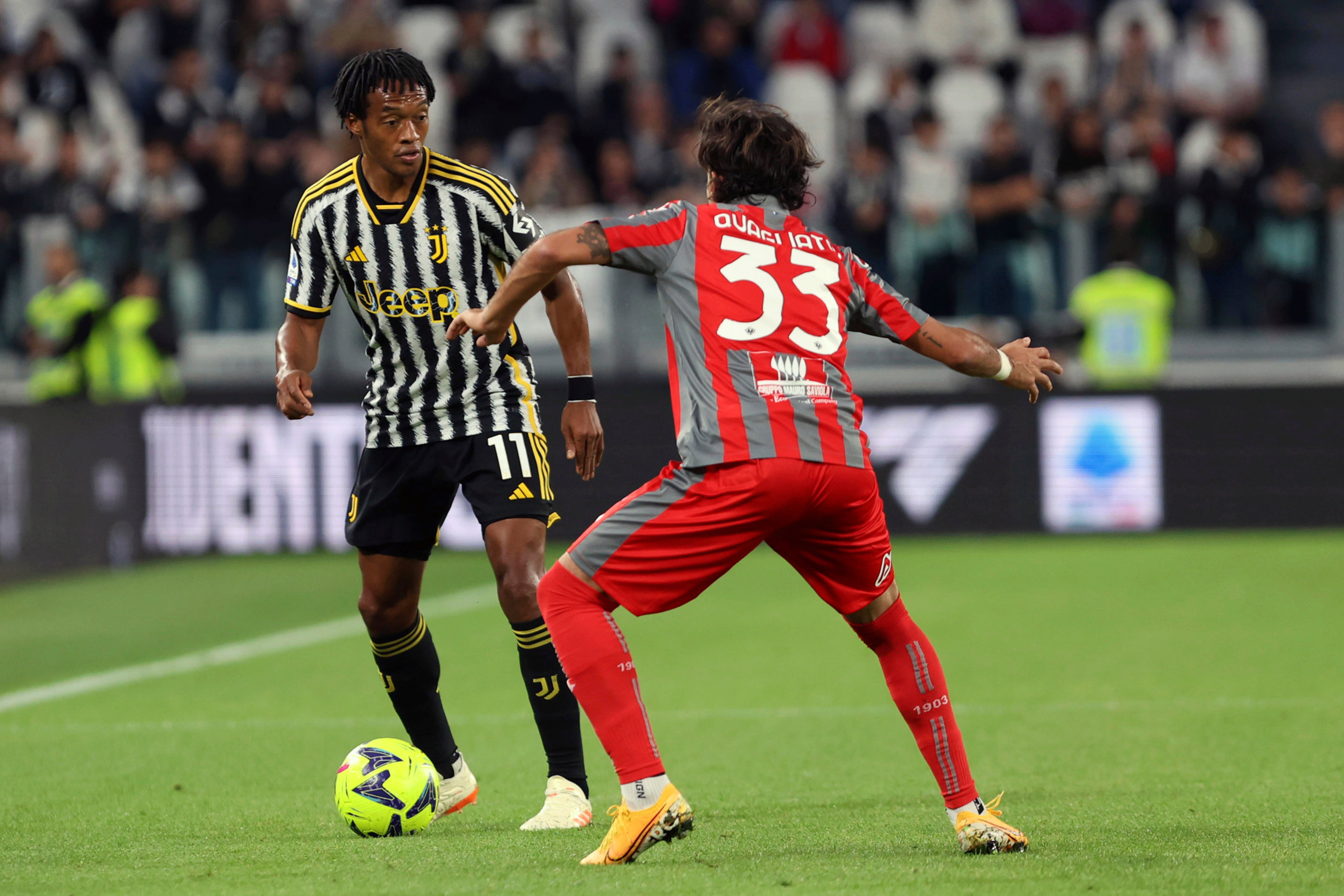 Juventus' Cuadrado, left, in action against Cremonese's Quagliata during the Serie A soccer match between Juventus and Cremonese at the Allianz Stadium in Turin, Italy, Sunday May 14, 2023. (Tano Pecoraro/LaPresse via AP)