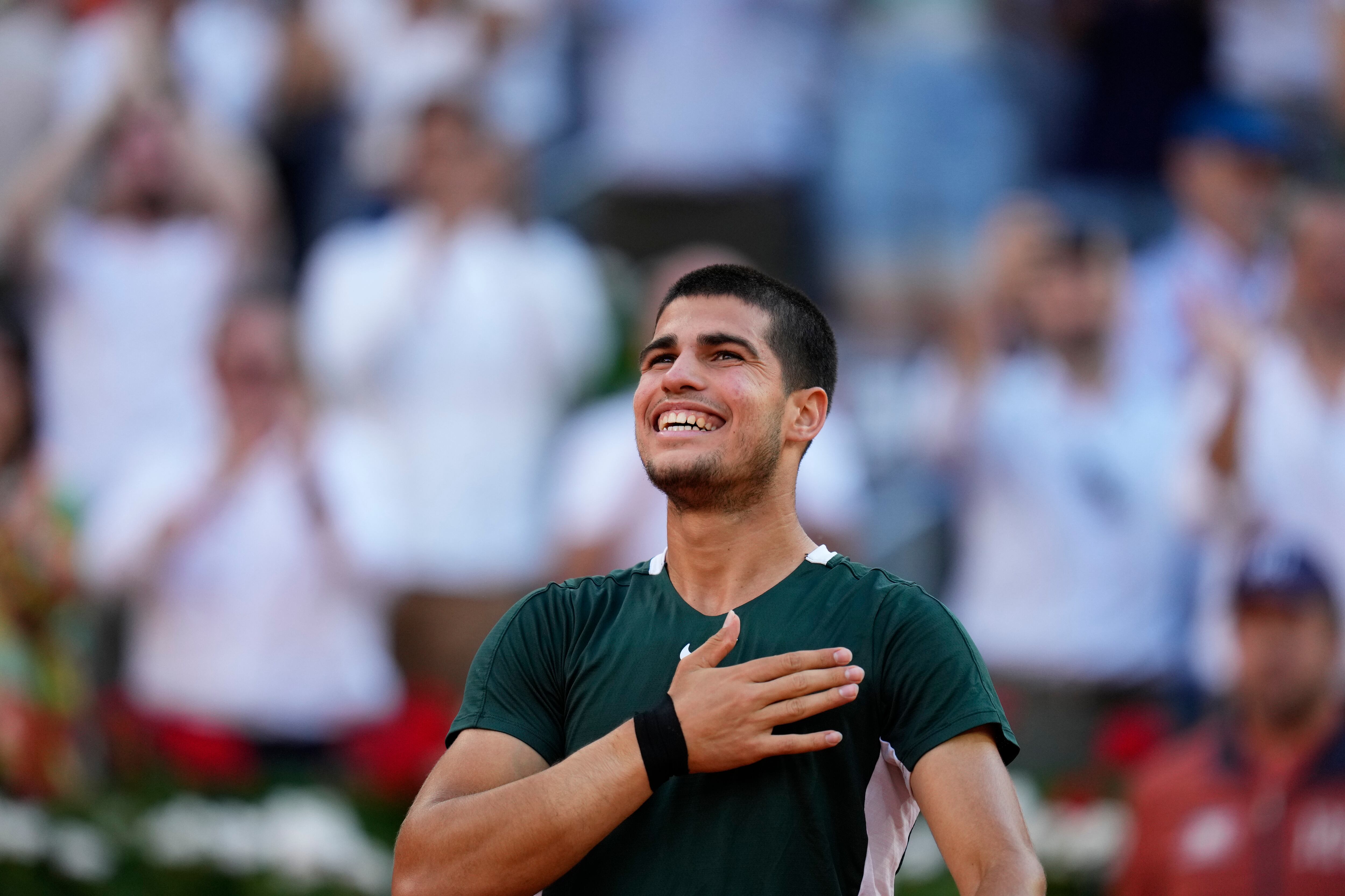 Carlos Alcaraz celebrates after defeating Novak Djokovic during a men's semifinal at the Mutua Madrid Open tennis tournament in Madrid, Spain, Saturday, May 7, 2022. (AP Photo/Manu Fernandez)