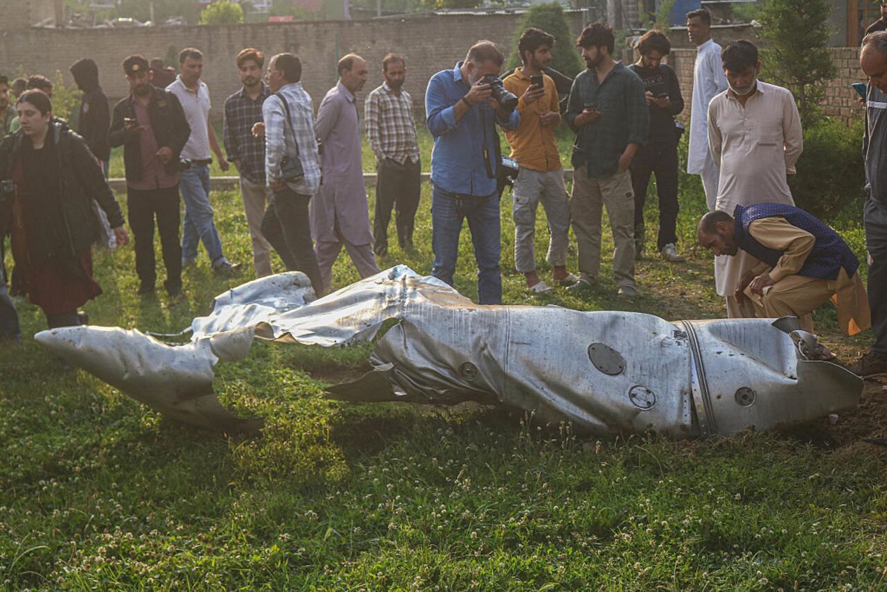 People look at a part of an unidentified aircraft in Pampore, Pulwama district, south of Srinagar, Jammu and Kashmir, on May 7, 2025. The Indian government says it carries out military strikes on nine sites in Pakistan in retaliation for the deadly militant attack on tourists in the popular tourist resort of Pahalgam in south Kashmir on April 22, 2025, which leaves 26 tourists dead. (Photo by Firdous Nazir/NurPhoto via Getty Images)