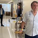 This handout photo obtained from the twitter account of Brazil's President Jair Bolsonaro (@jairbolsonaro), shows Brazil's President Jair Bolsonaro walking at the Vila Nova Star Hospital, in Sao Paulo, Brazil, on July 16, 2021. - Brazil President Jair Bolsonaro was making satisfactory progress according to the hospital where he is receiving treatment for a blocked intestine. Far right leader Bolsonaro was taken to a military hospital in the capital Brasilia on Wednesday after suffering persistent hiccups and abdominal pain for around 10 days. (Photo by - / Jair Bolsonaro's official Twitter account / AFP) / RESTRICTED TO EDITORIAL USE - MANDATORY CREDIT "AFP PHOTO / Jair Bolsonaro's official Twitter account (@jairbolsonaro) " - NO MARKETING - NO ADVERTISING CAMPAIGNS - DISTRIBUTED AS A SERVICE TO CLIENTS