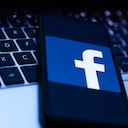 Facebook logo displayed on a phone screen and a laptop keyboard are seen in this illustration photo taken in Krakow, Poland on October 20, 2021. (Photo by Jakub Porzycki/NurPhoto via Getty Images)