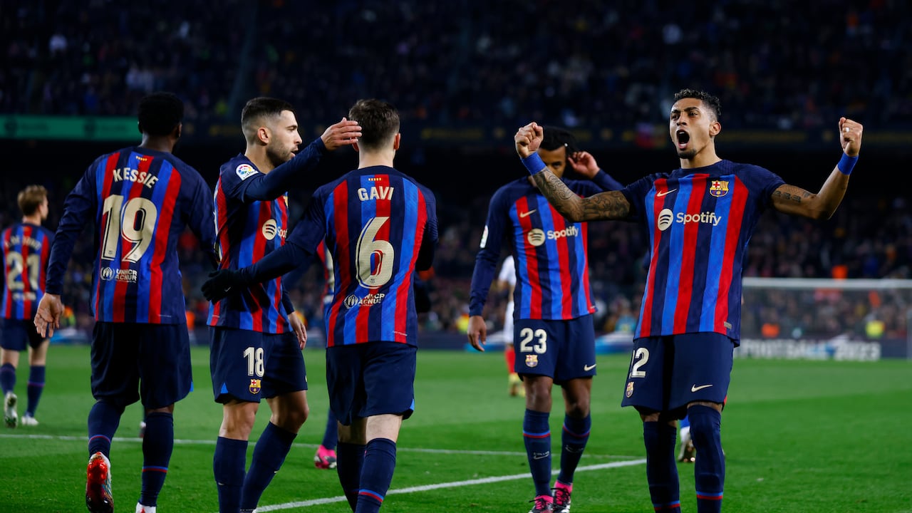 Barcelona's Raphinha, right, celebrates after scoring his side's third goal during a Spanish La Liga soccer match between Barcelona and Sevilla at the Camp Nou stadium in Barcelona, Spain, Sunday, Feb. 5, 2023. (AP Photo/Joan Monfort)