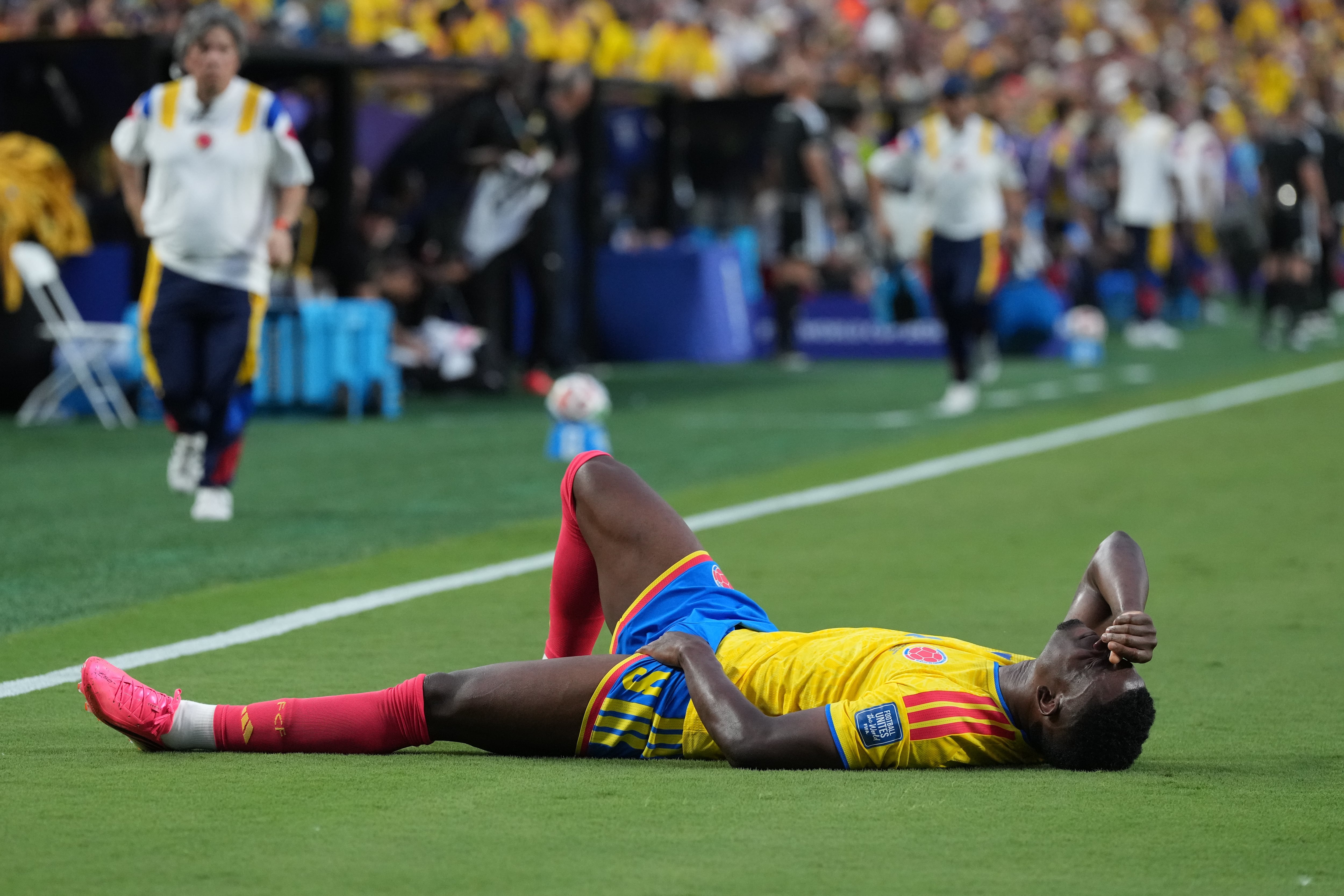 Colombia's Jhon Cordoba grimaces in pain during the World Cup round of 32 soccer match between Colombia and Ghana in Kansas City, Mo., Friday, July 3, 2026. (AP Photo/Jeff Roberson)