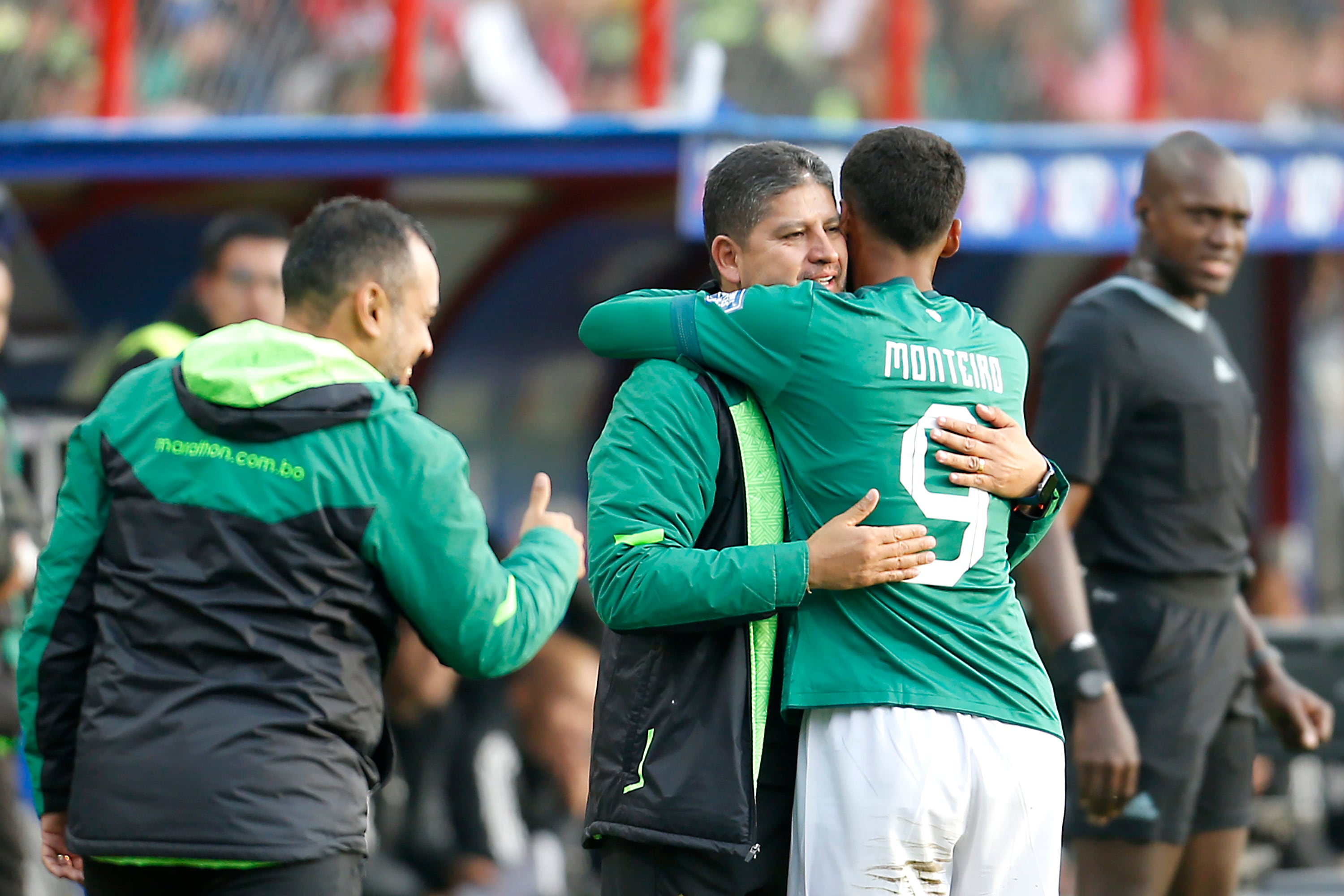 EL ALTO, BOLIVIA - SEPTEMBER 05: Enzo Monteiro (R) of Bolivia celebrates with his head coach Oscar Villegas (C) after scoring the team's fourth goal during the FIFA World Cup 2026 Qualifier match between Bolivia and Venezuela at Estadio Municipal De El Alto on September 05, 2024 in El Alto, Bolivia.  (Photo by Gaston Brito Miserocchi/Getty Images)