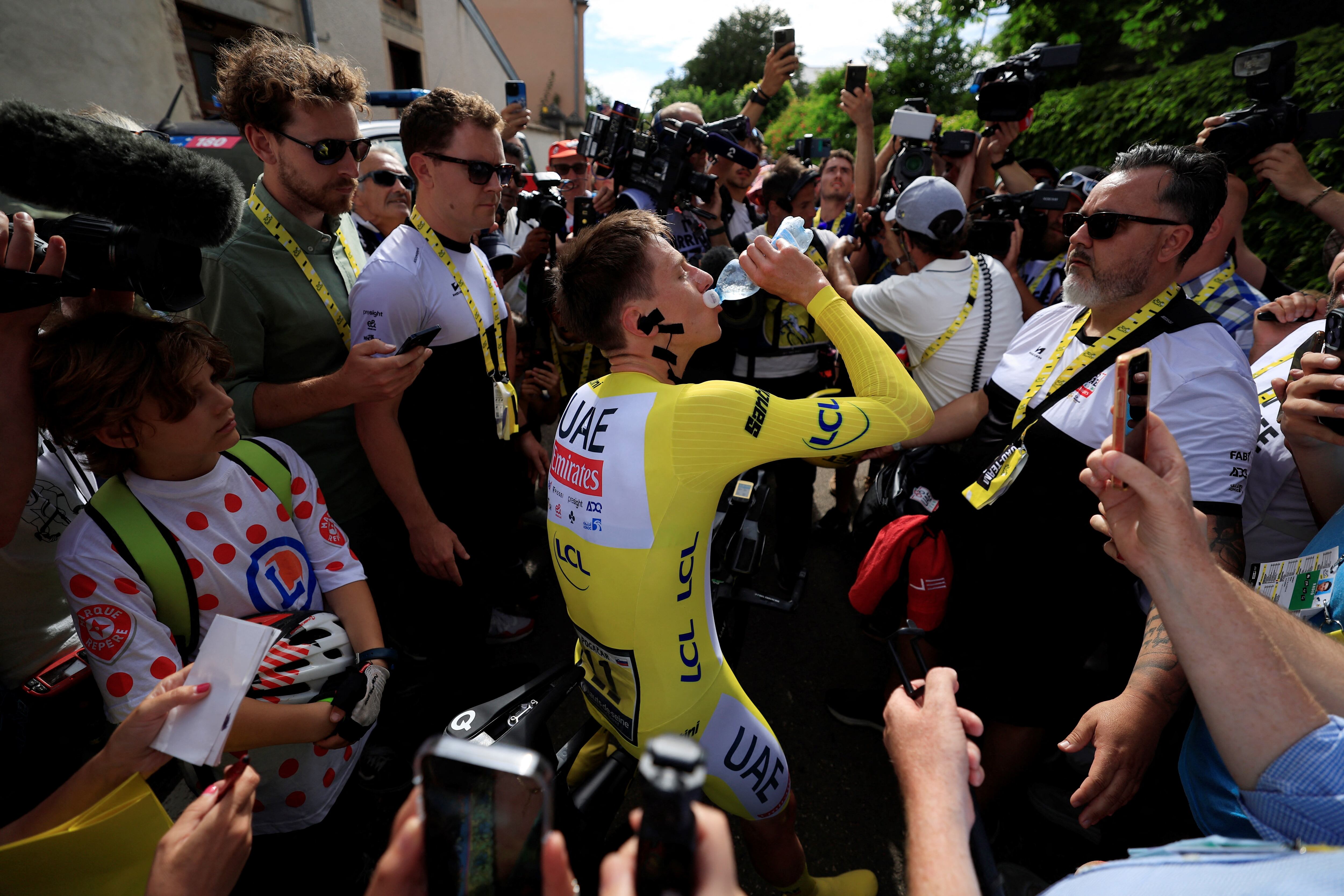 UAE Team Emirates team's Slovenian rider Tadej Pogacar drinks after the 7th stage of the 111th edition of the Tour de France cycling race, 25,3 km individual time trial between Nuits-Saint-Georges and Gevrey-Chambertin, on July 5, 2024. (Photo by Guillaume HORCAJUELO / POOL / AFP)