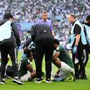 LUSAIL CITY, QATAR - NOVEMBER 22: Yasser Al-Shahrani of Saudi Arabia receives medical attention after a collision with teammate Mohammed Al-Owais (not pictured) during the FIFA World Cup Qatar 2022 Group C match between Argentina and Saudi Arabia at Lusail Stadium on November 22, 2022 in Lusail City, Qatar. (Photo by Matthias Hangst/Getty Images)