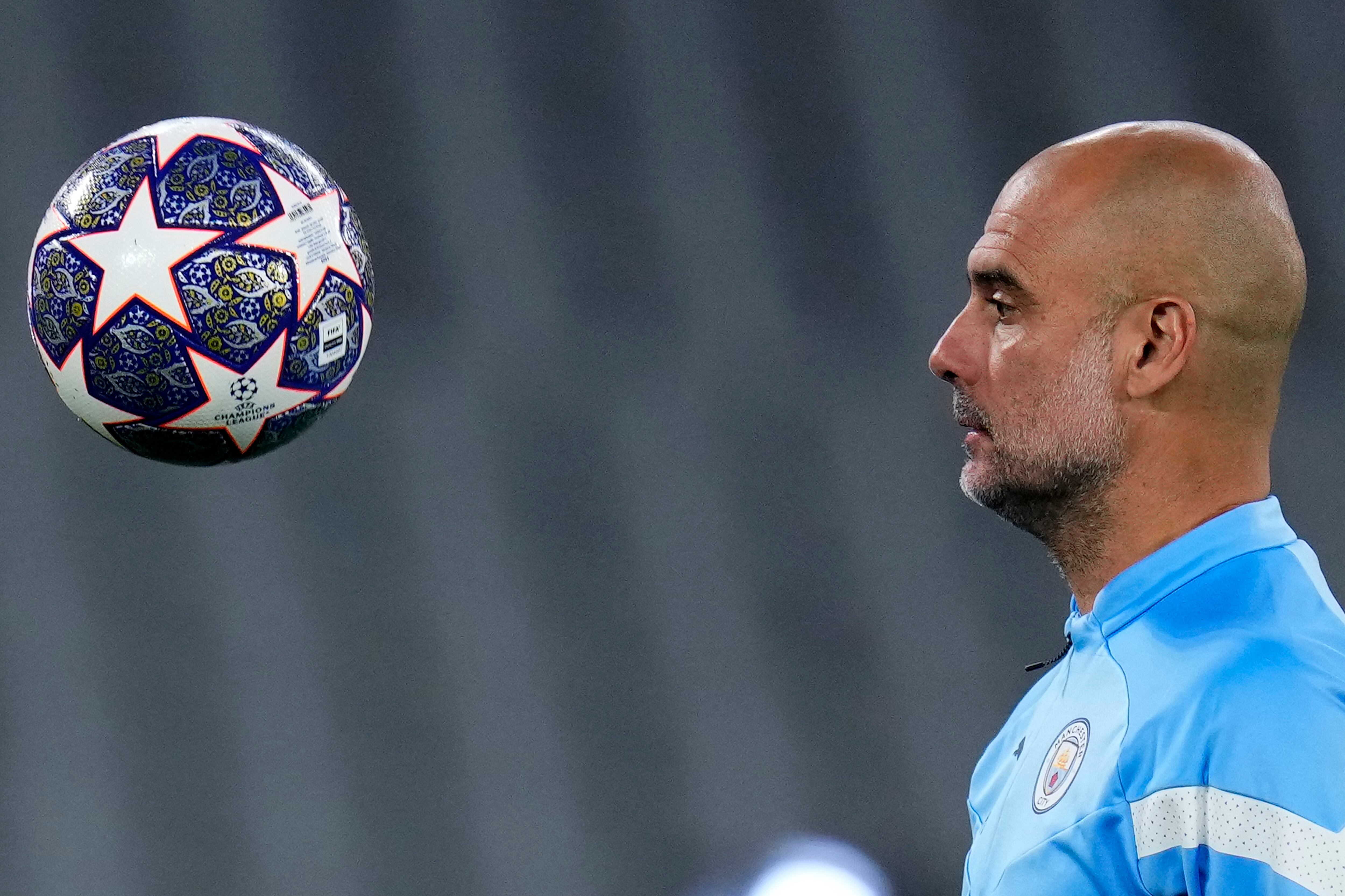Manchester City's head coach Pep Guardiola eyes the ball during a training session at the Ataturk Olympic Stadium in Istanbul, Turkey, Friday, June 9, 2023. Manchester City and Inter Milan are making their final preparations ahead of their clash in the Champions League final on Saturday night. (AP Photo/Manu Fernandez)