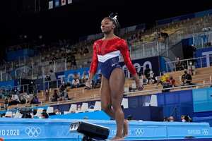 Simone Biles, of the United States, walks after performing on the vault during the artistic gymnastics women's final at the 2020 Summer Olympics, Tuesday, July 27, 2021, in Tokyo. (AP Photo/Ashley Landis)