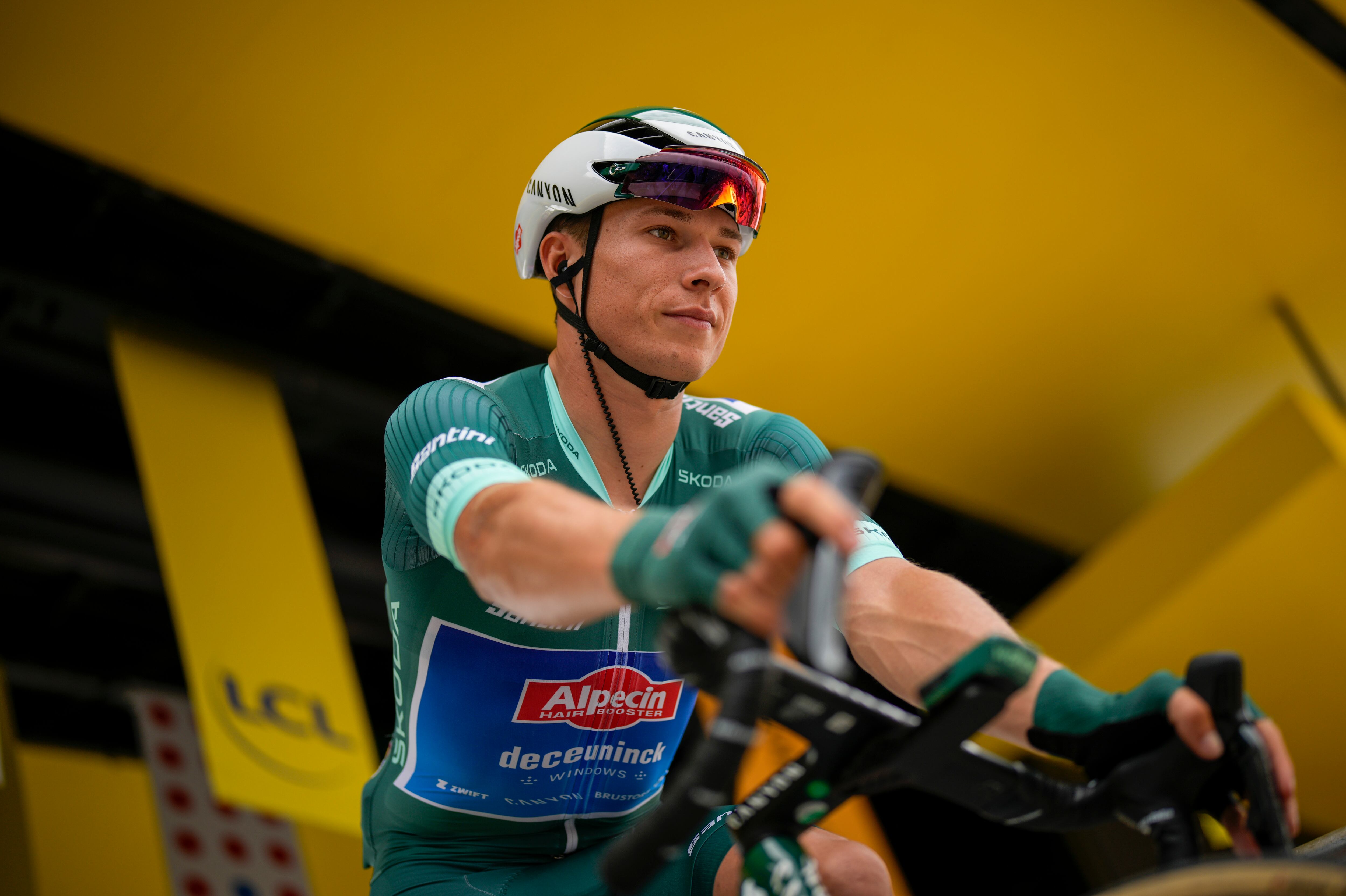 Belgium's Jasper Philipsen, wearing the best sprinter's green jersey, is seen on the podium prior to the eleventh stage of the Tour de France cycling race over 180 kilometers (112 miles) with start in Clermont-Ferrand and finish in Moulins, France, Wednesday, July 12, 2023. (AP Photo/Daniel Cole)