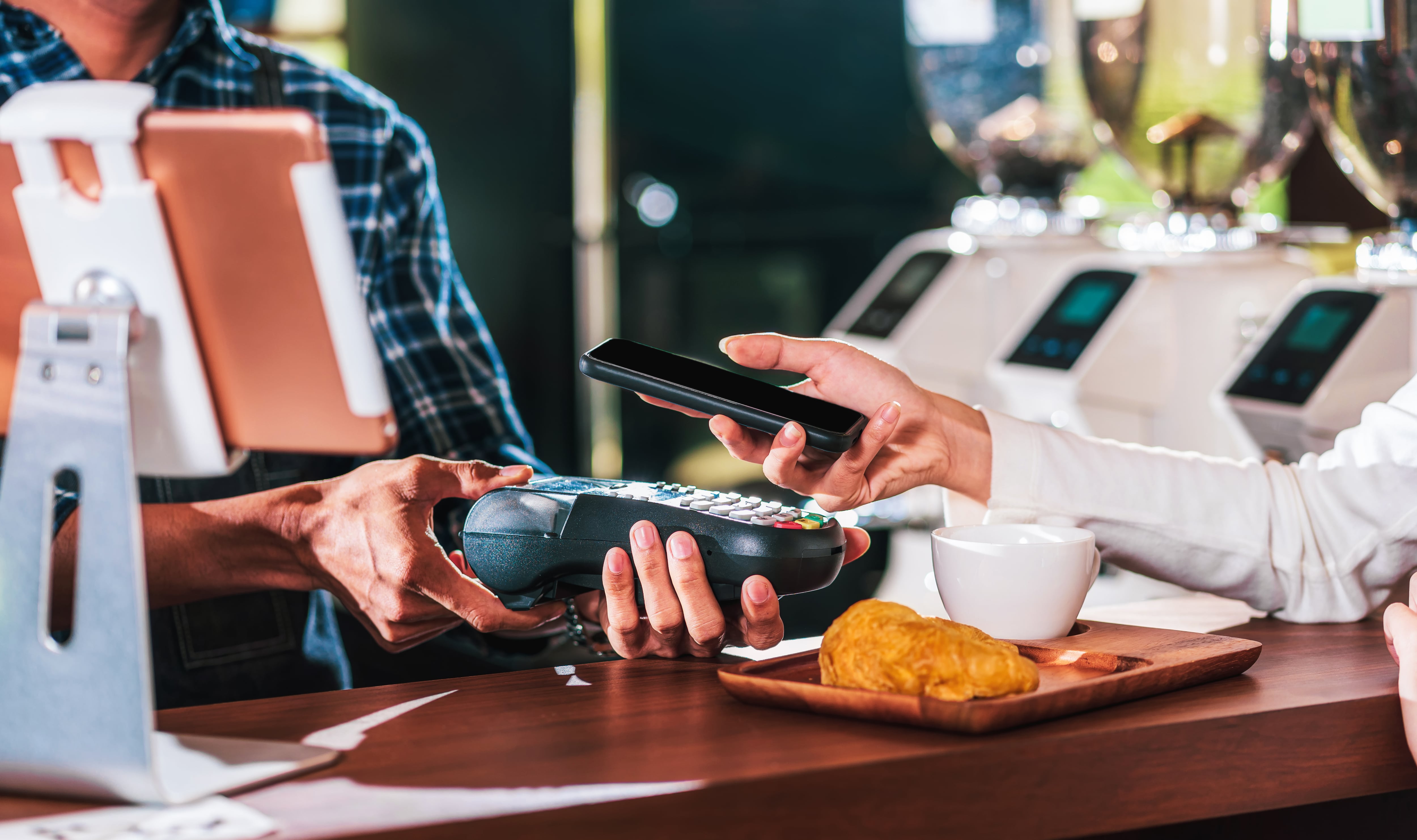 Propietario de una pequeña empresa y puesta en marcha en una cafetería, Primer cliente asiático mano del hombre pagando dinero a través del canal sin contacto mediante la aplicación de banca móvil al propietario de una pequeña empresa en la mesa de la cafetería