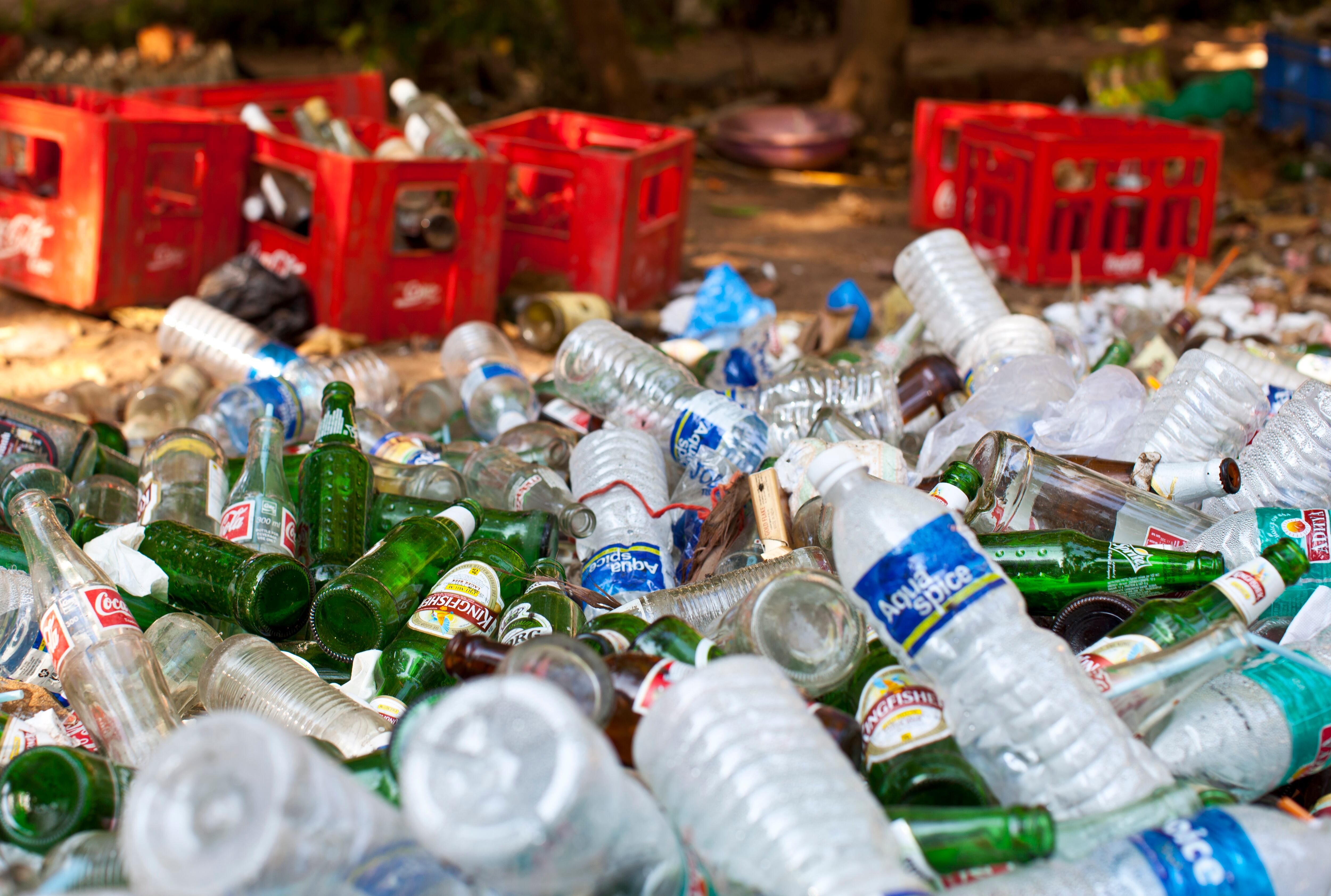 GOA, INDIA - FEBRUARY 01: Garbage and litter from plastic bottles and glass bottles of coca cola and beer lie at the beach of Vagator on February 1, 2012 in Goa, India  (Photo by EyesWideOpen/Getty Images)