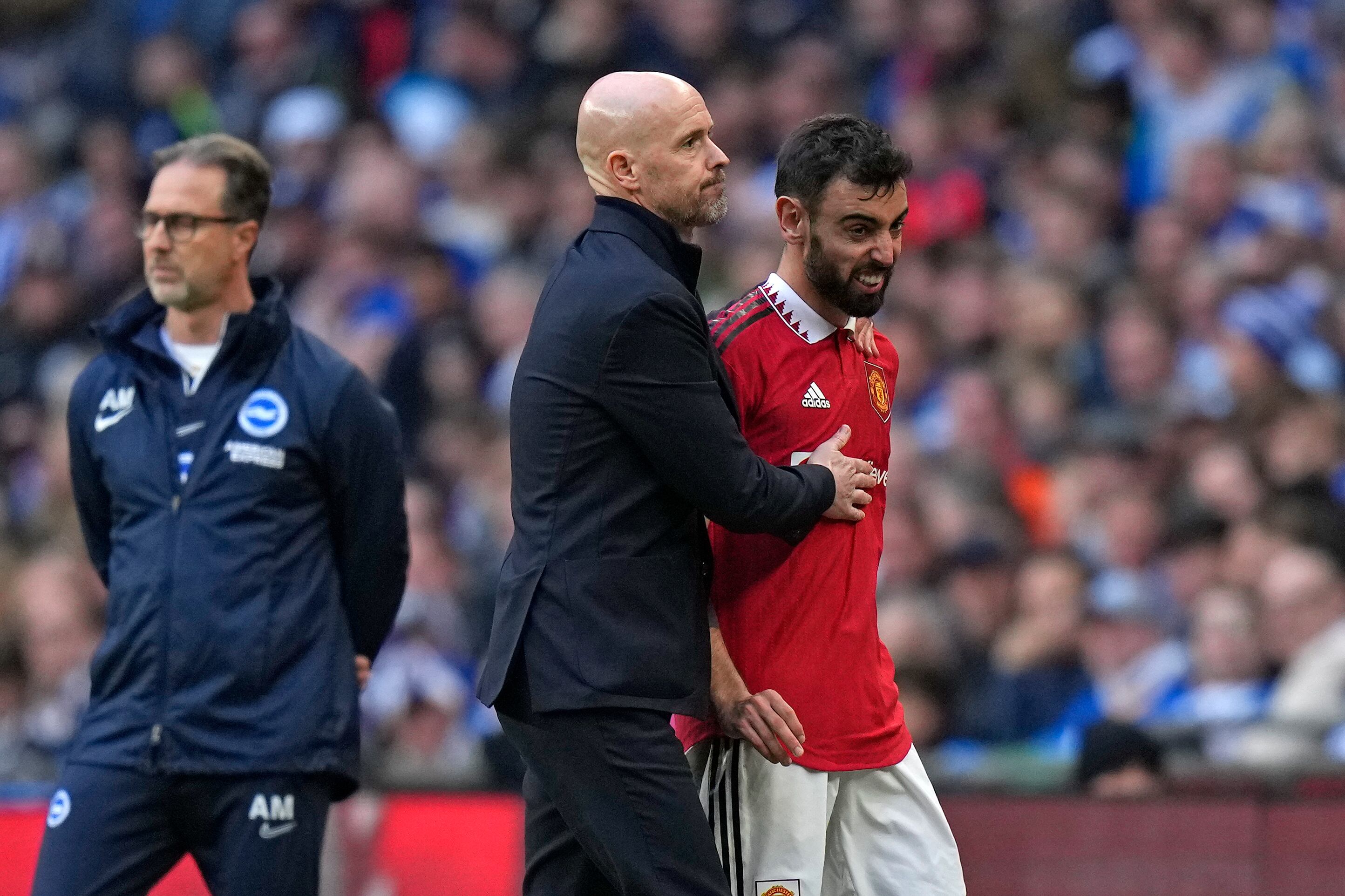 Manchester United's Bruno Fernandes is substituted by Manchester United's head coach Erik ten Hag during the English FA Cup semifinal soccer match between Brighton and Hove Albion and Manchester United at Wembley Stadium in London, Sunday, April 23, 2023. (AP Photo/Alastair Grant)