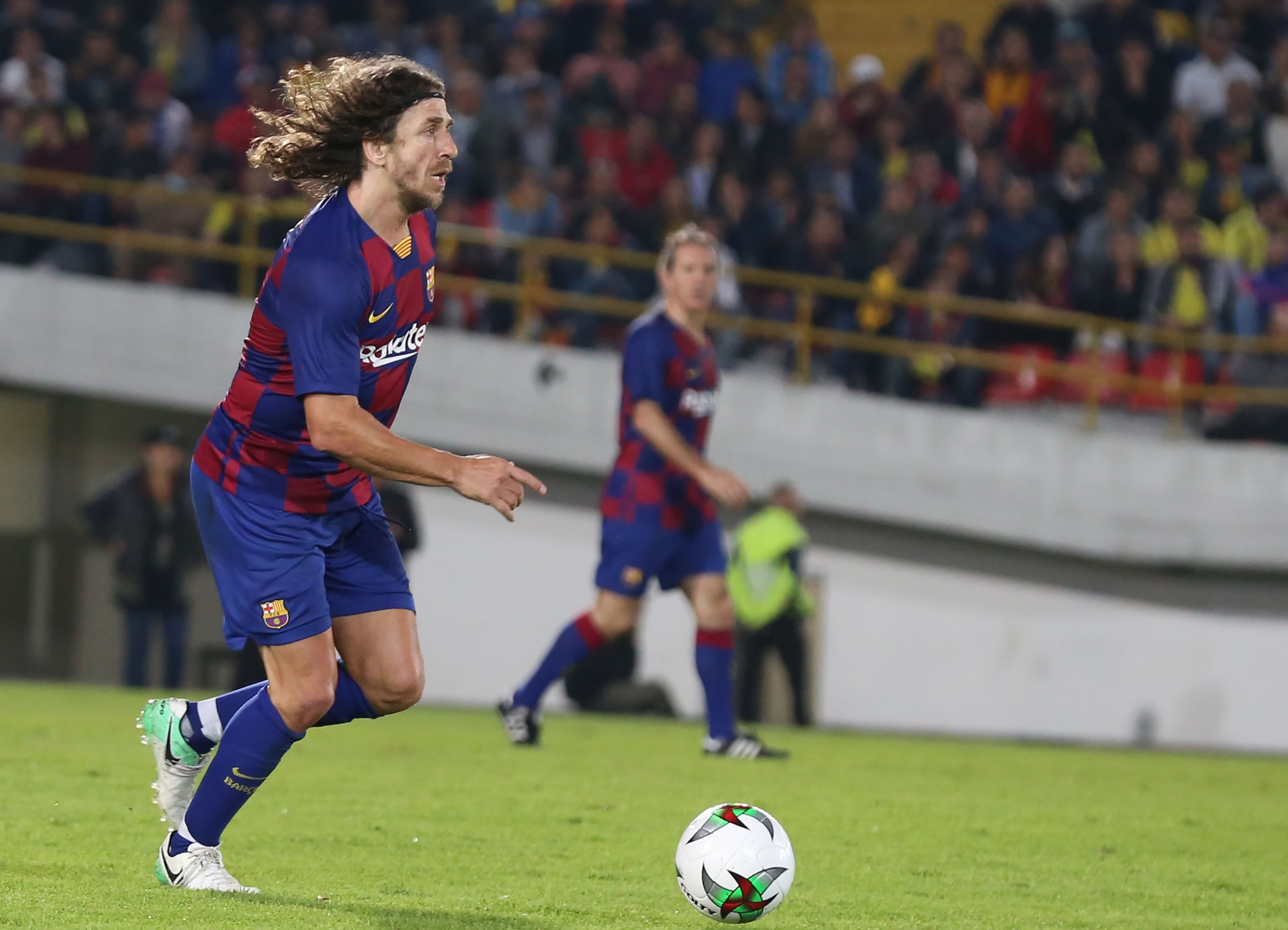 BOGOTA, COLOMBIA - MARCH 5: Former Spanish soccer player from Barca Legends Carles Puyol controls the ball against Colombia Legends during a friendly match at El Campin stadium in Bogota, Colombia, 5 March 2020. Spanish team of former soccer players Barca Legends was lead by Albert Ferrer, with such players as Juliano Belletti, Carles Puyol, Hristo Stoichkov and Javier Saviola. Colombian legends, coached by Francisco Maturana, include El Pibe Valderrama, Ivan Ramiro Cordoba, Freddy Rincon, Victor Hugo Aristizabal and Farid Mondragon. (Photo by Juan David Moreno Gallego/Anadolu Agency via Getty Images)