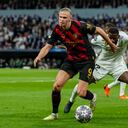 Manchester City's Erling Haaland, left, duels for the ball with Real Madrid's Antonio Rudiger during the Champions League semifinal first leg soccer match between Real Madrid and Manchester City at the Santiago Bernabeu stadium in Madrid, Spain, Tuesday, May 9, 2023. (AP Photo/Jose Breton)
