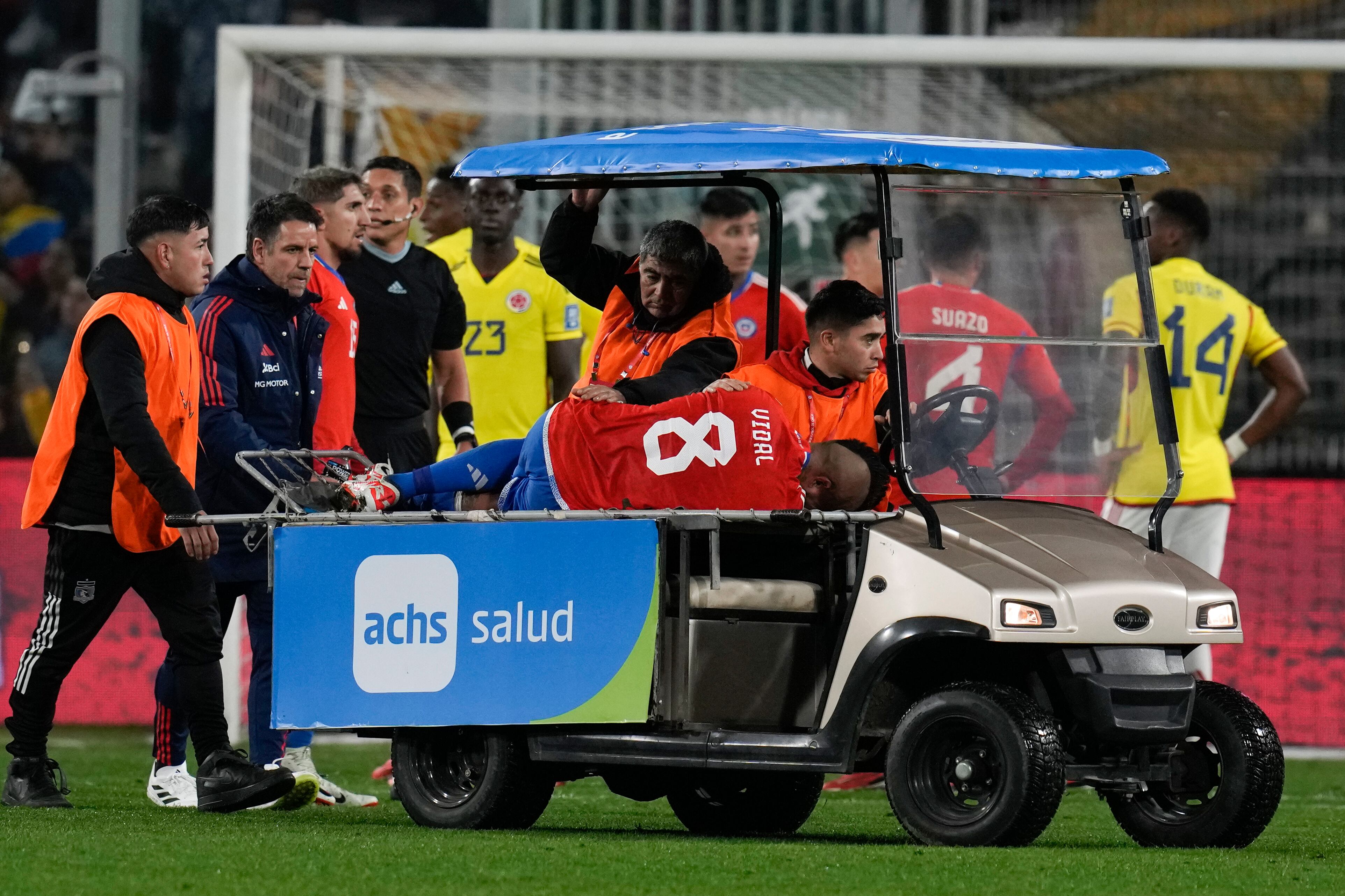 Chile's Arturo Vidal is taken out the field injured during a qualifying soccer match against Colombia for the FIFA World Cup 2026 at Monumental stadium in Santiago, Chile, Tuesday, Sept. 12, 2023. (AP Photo/Esteban Felix)