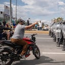 A demonstrator confronts the police during a national strike, in Guatemala City, Tuesday, Oct. 10, 2023. People are protesting to support President-elect Bernardo Arévalo after Guatemala's highest court upheld a move by prosecutors to suspend his political party over alleged voter registration fraud. (AP Photo/Santiago Billy)