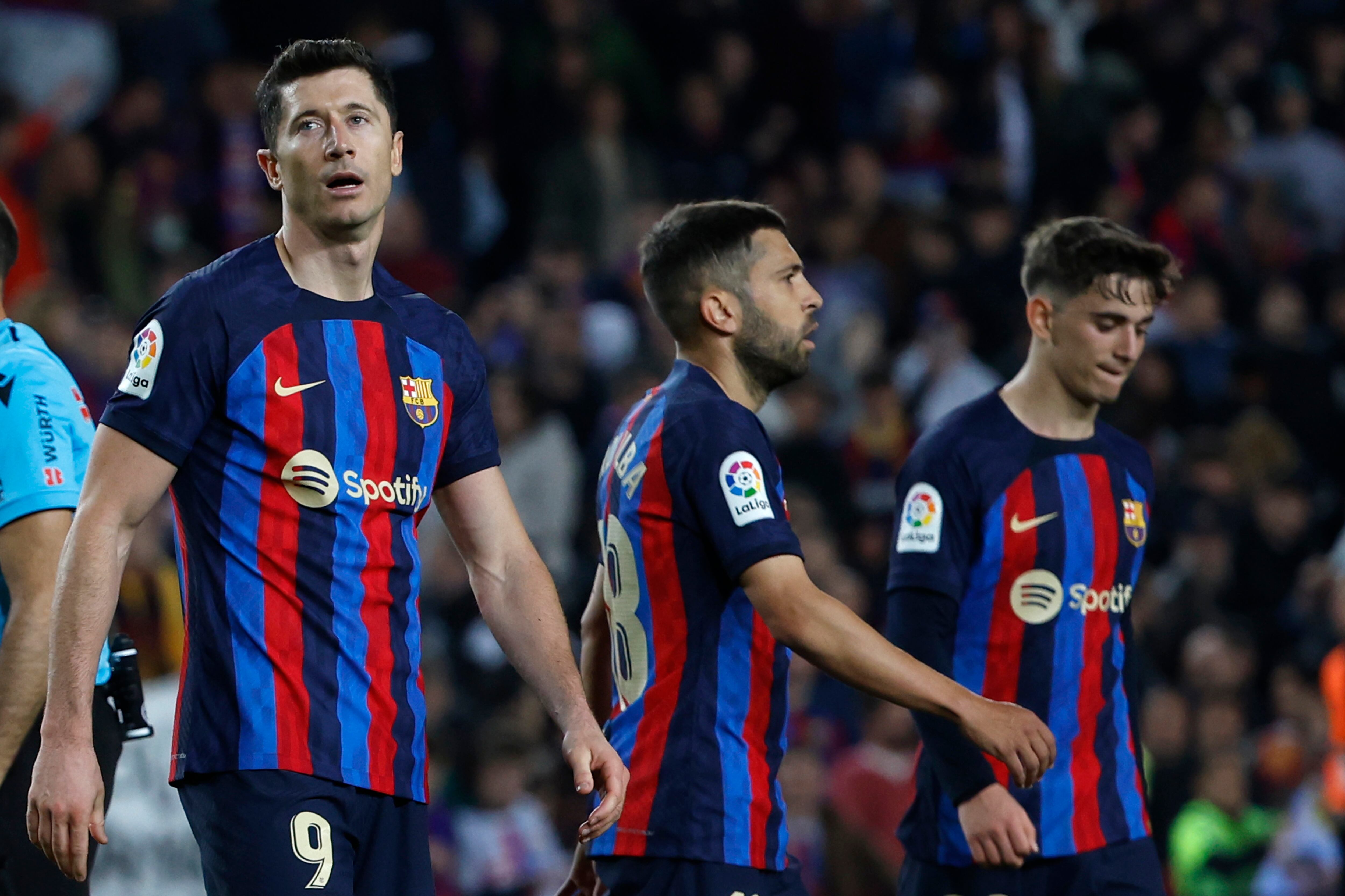 Barcelona's Robert Lewandowski, left, Barcelona's Gavi, right, and Barcelona's Jordi Alba gesture at the end of the Spanish La Liga soccer match between Barcelona and Girona at the Camp Nou stadium in Barcelona, Spain, Monday, April 10, 2023. (AP Photo/Joan Monfort)